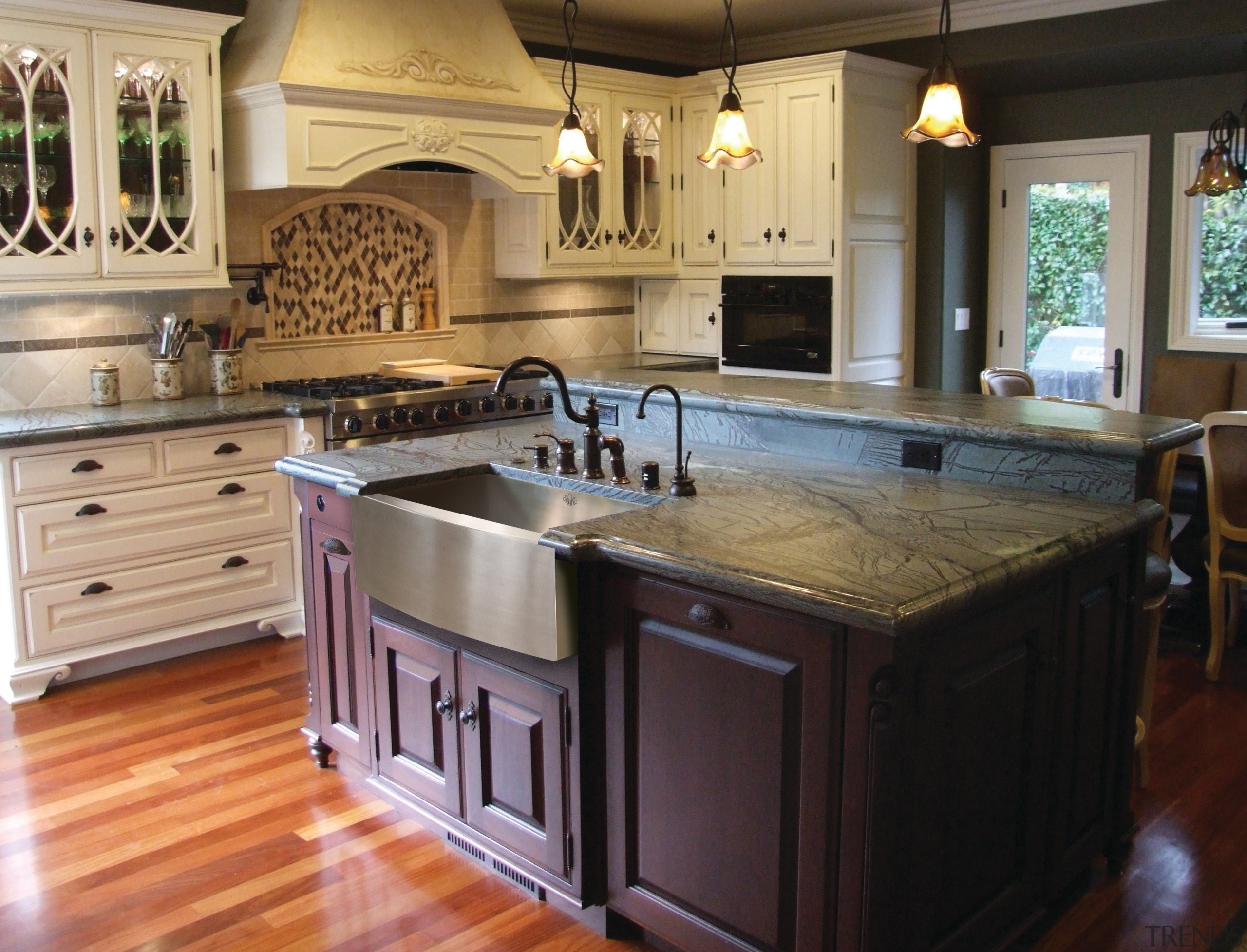 View of kitchen which features sink and arched cabinetry, countertop, cuisine classique, floor, flooring, hardwood, interior design, kitchen, room, wood flooring, black