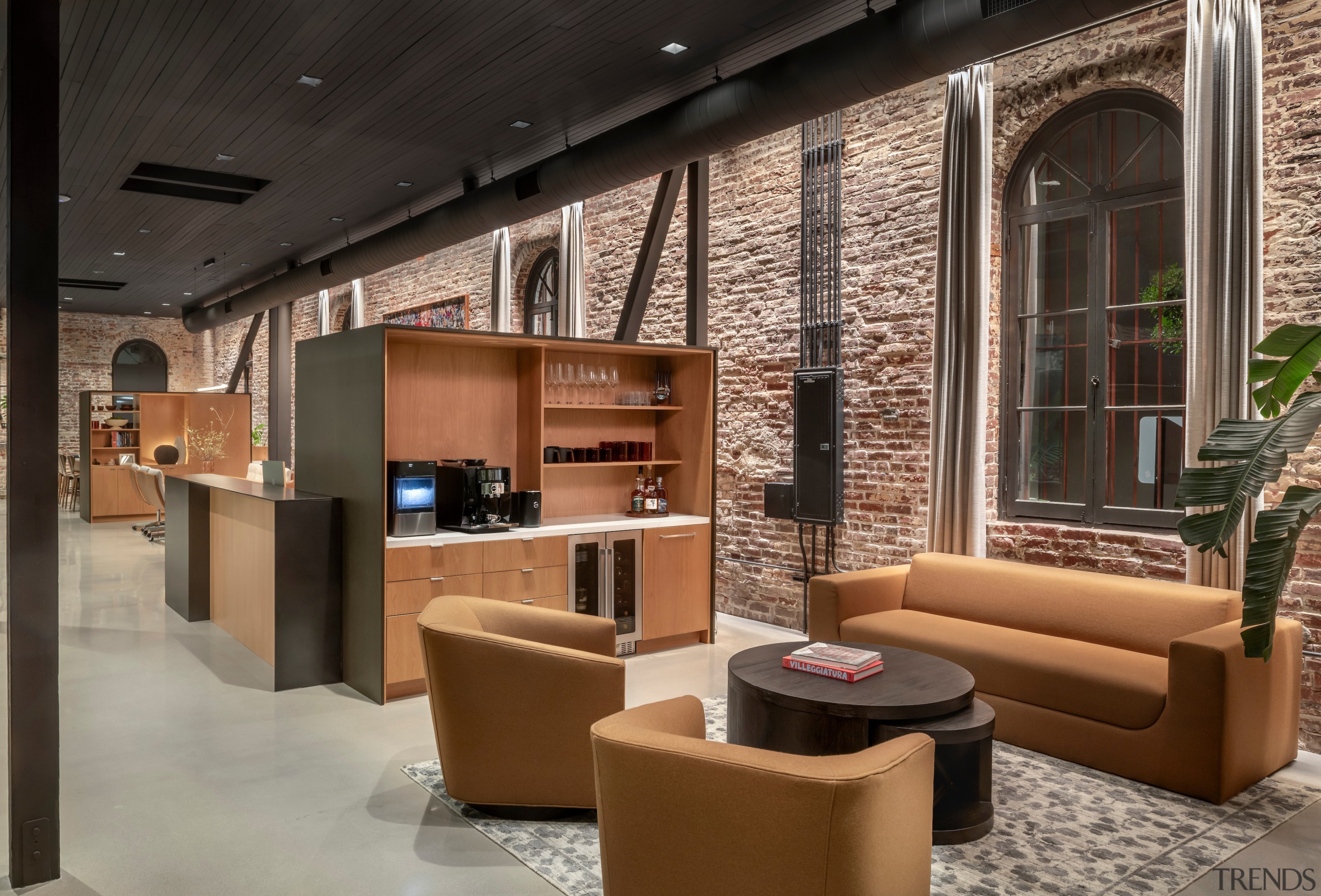 Furniture and cabinetry tones with teh red brickwork. 