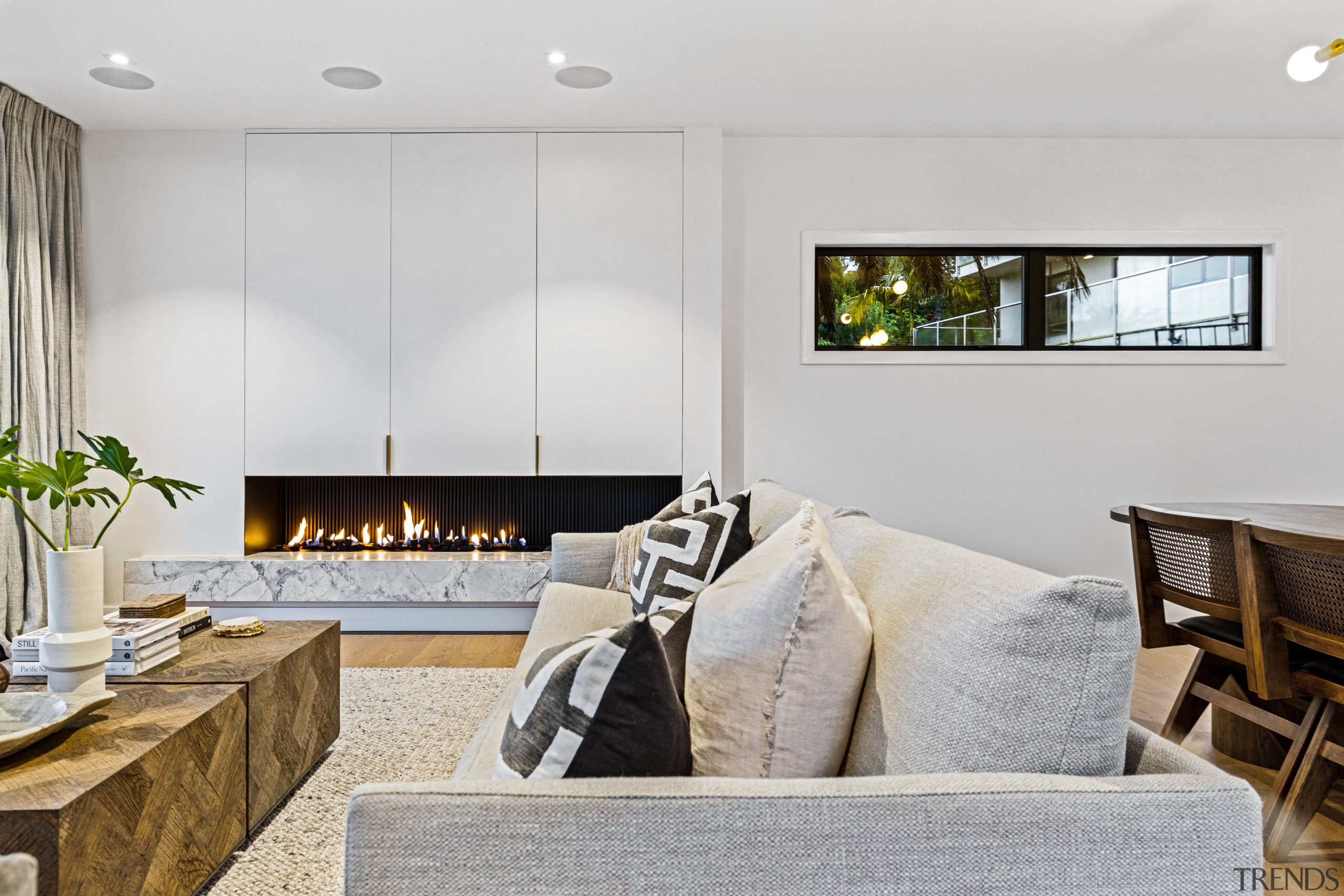 The living room with custom indoor steel-backed fireplace 