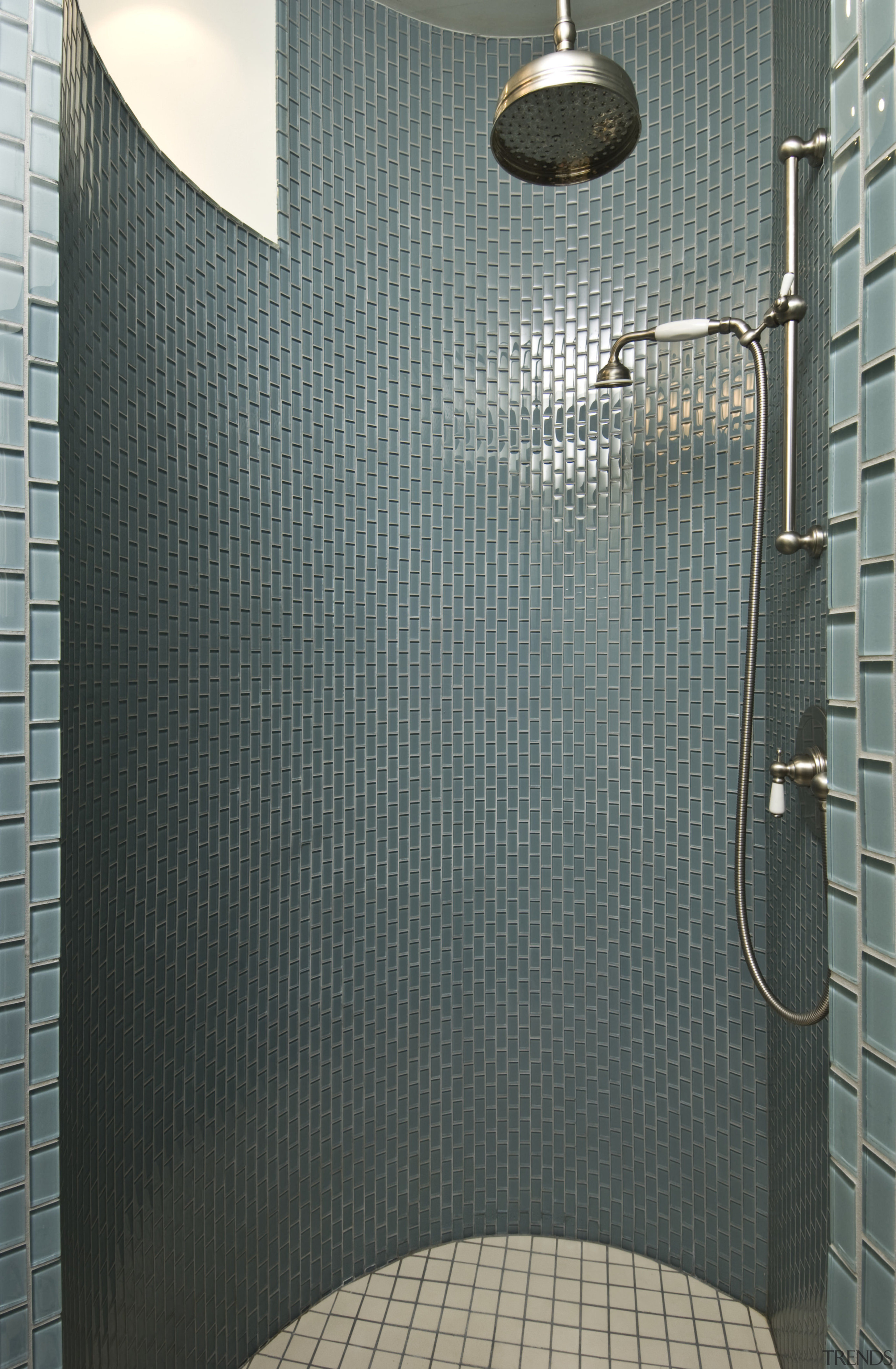 View of shower enclosure which features tiling, shower bathroom, plumbing fixture, room, shower, tile, gray, black