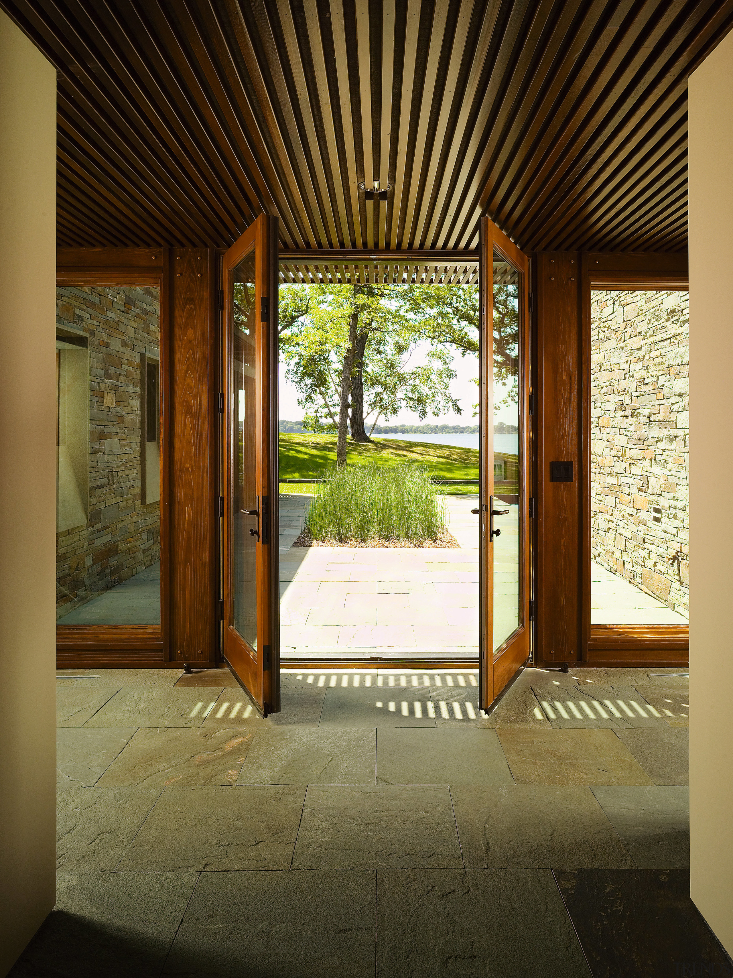 A view of a entrance way, stone tiled architecture, ceiling, door, estate, home, house, interior design, property, real estate, window, wood, brown