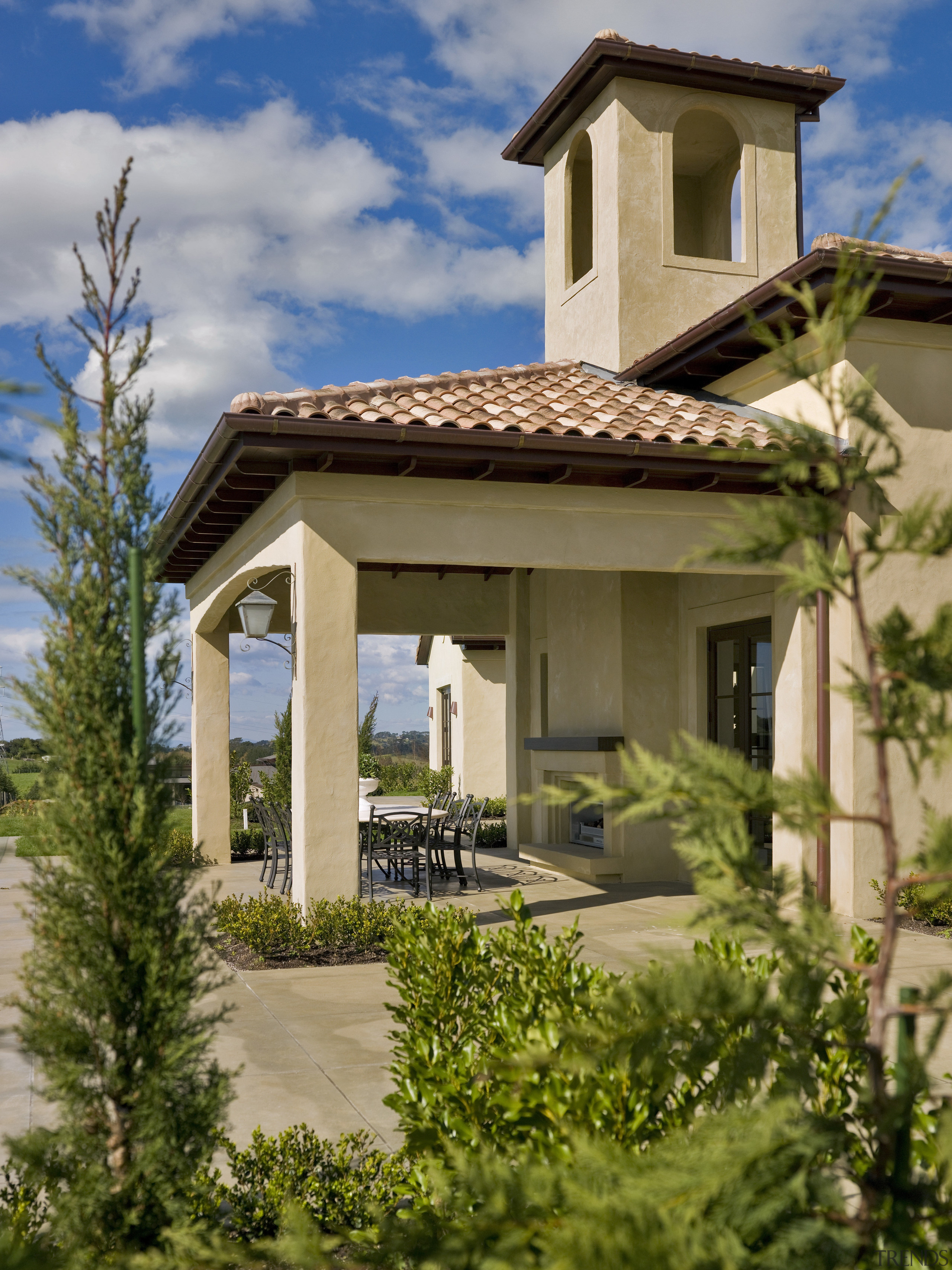 A view of a home designed by Masonry cottage, estate, facade, home, house, outdoor structure, property, real estate, residential area, roof, sky, villa, brown