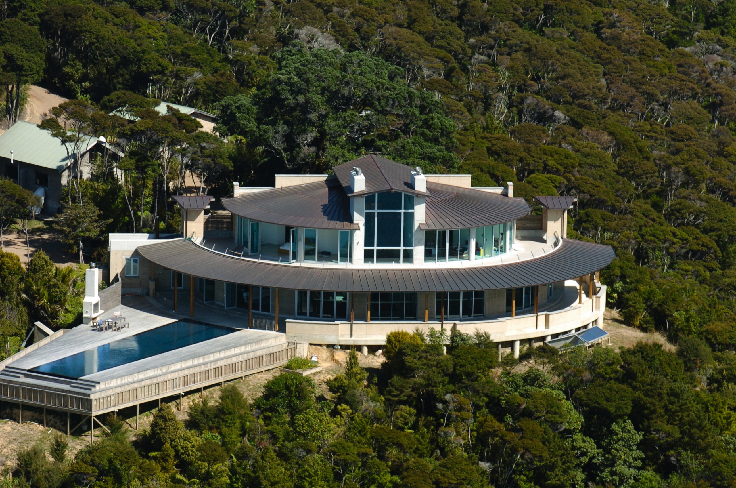 A high shot of a large cliff top architecture, building, estate, home, house, mansion, property, real estate, residential area, villa, brown