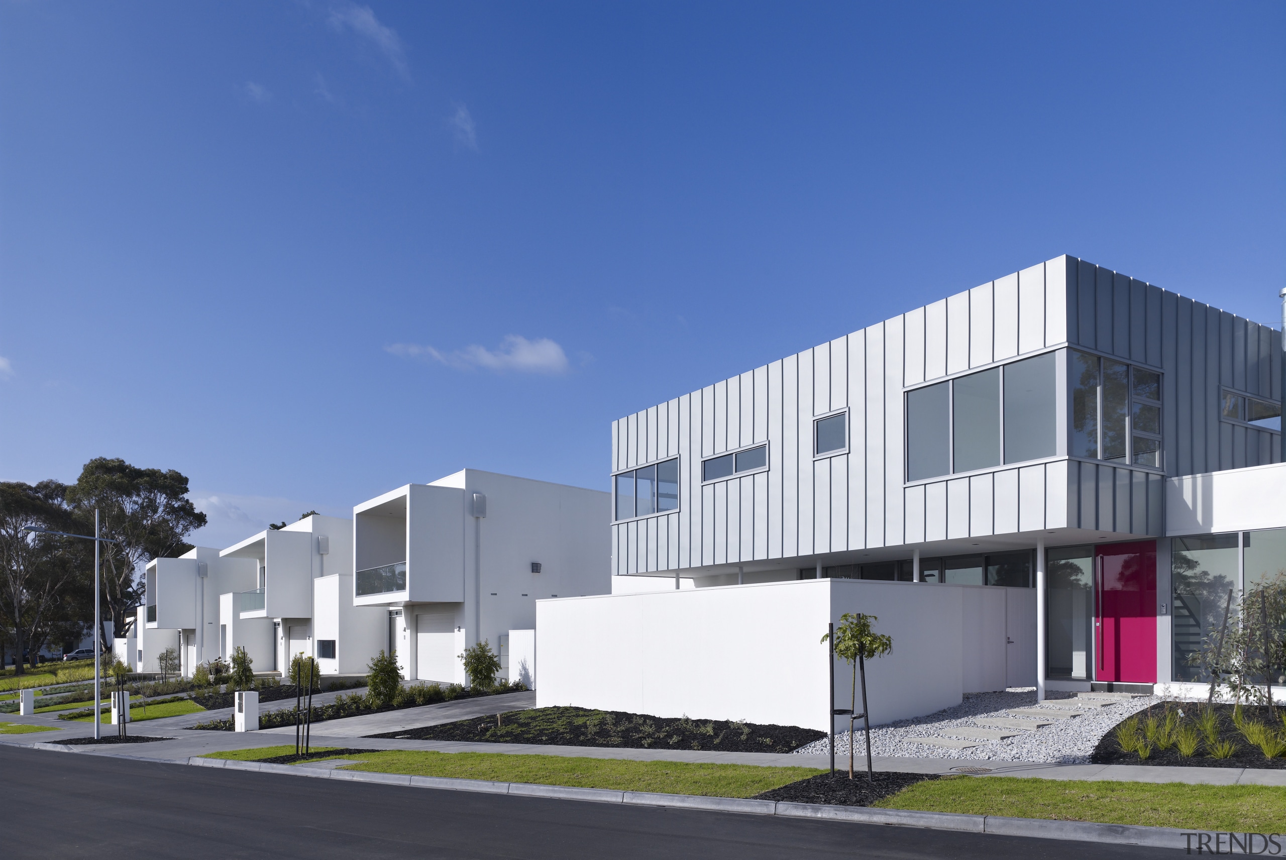 View of the exterior of the town houses architecture, building, commercial building, corporate headquarters, elevation, facade, headquarters, home, house, mixed use, neighbourhood, property, real estate, residential area, sky, blue