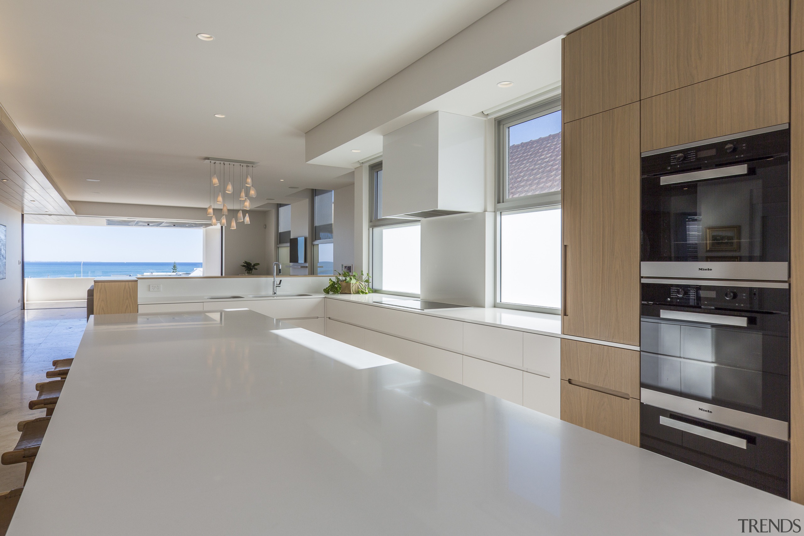 Above: A large island is ideal for family architecture, kitchen, travertine benchtop