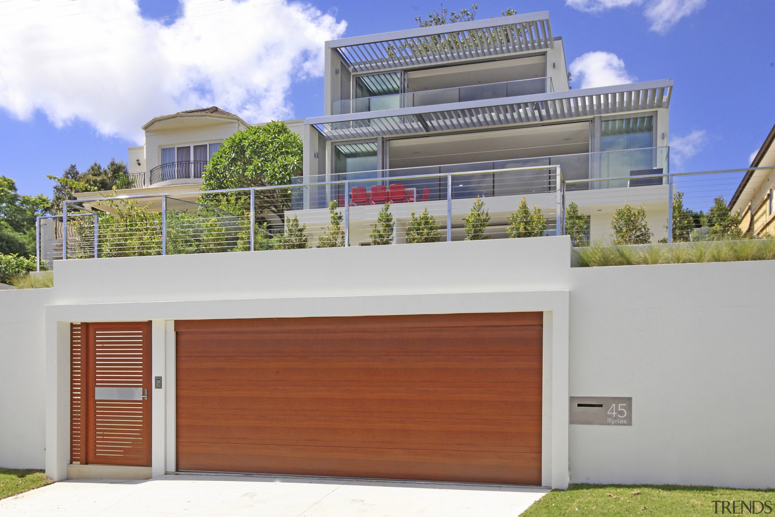 Exterior of house with wooden garage door. - architecture, building, elevation, estate, facade, home, house, official residence, property, real estate, residential area, white, gray