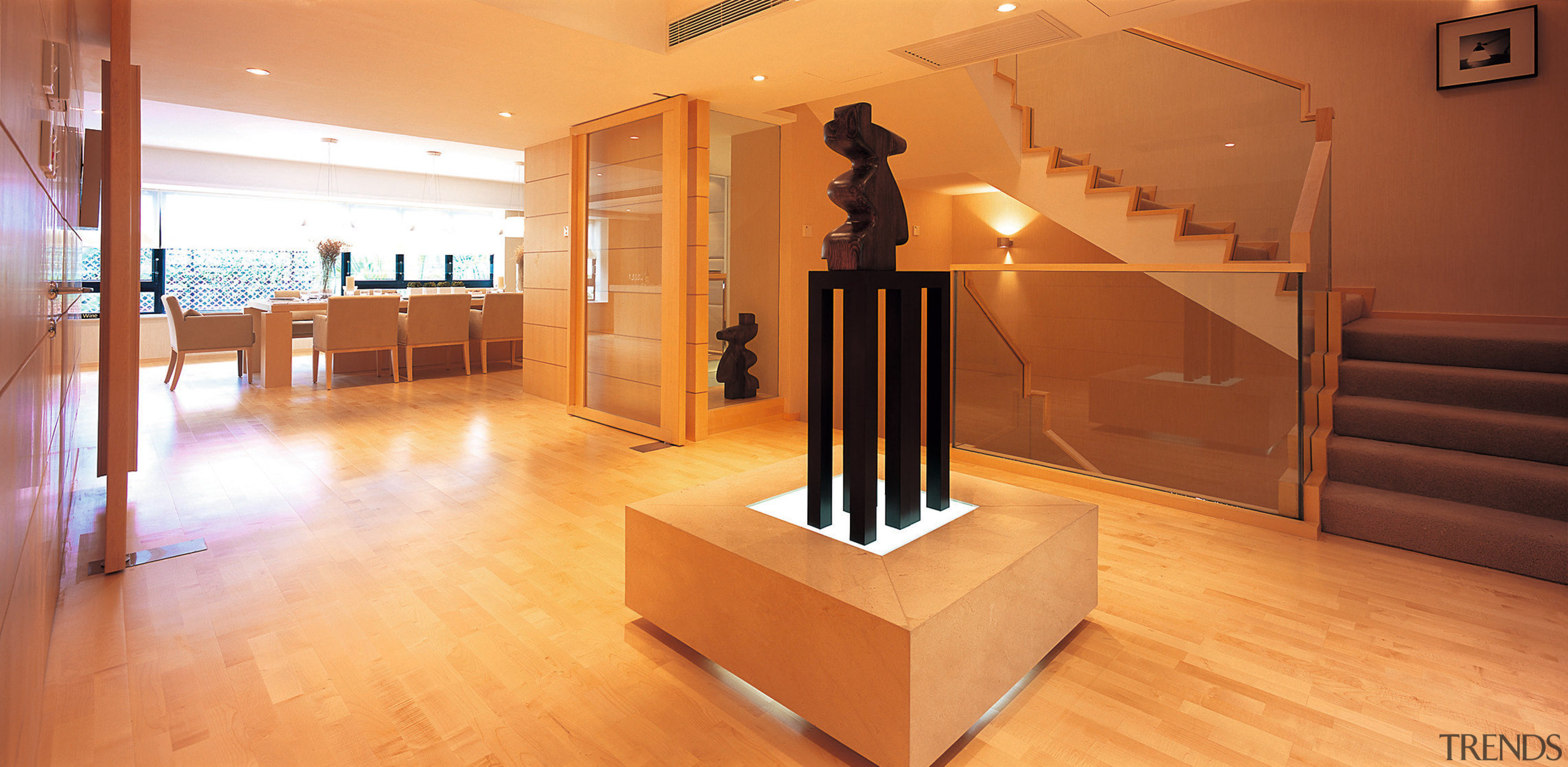 A view of another lobby containing a sculpture floor, flooring, furniture, hardwood, interior design, laminate flooring, room, stairs, wood, wood flooring, orange