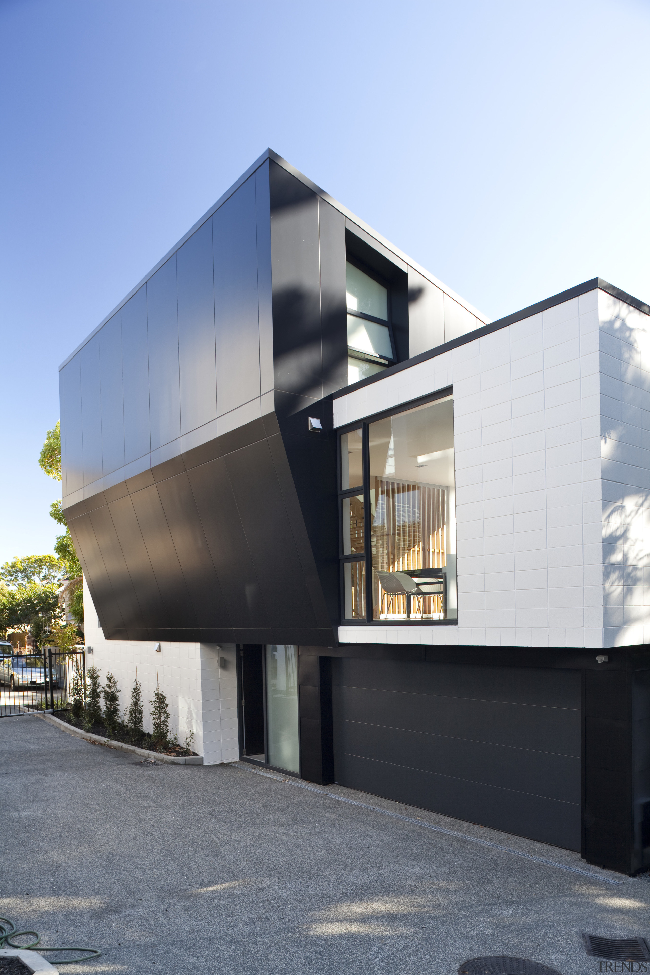 View of exterior with dark sloping wall. - architecture, building, facade, house, residential area, white