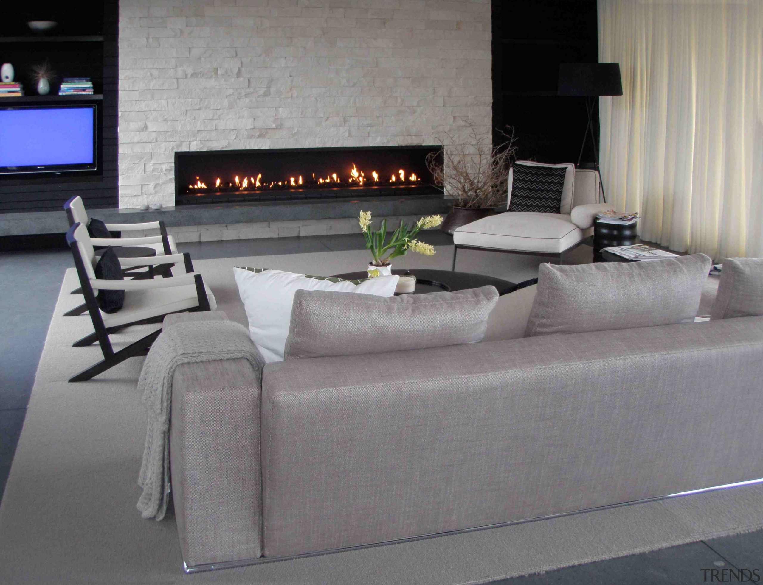 Eye-catching fireplaces are designed and constructed by architectural floor, flooring, furniture, interior design, living room, luxury vehicle, table, wall, gray