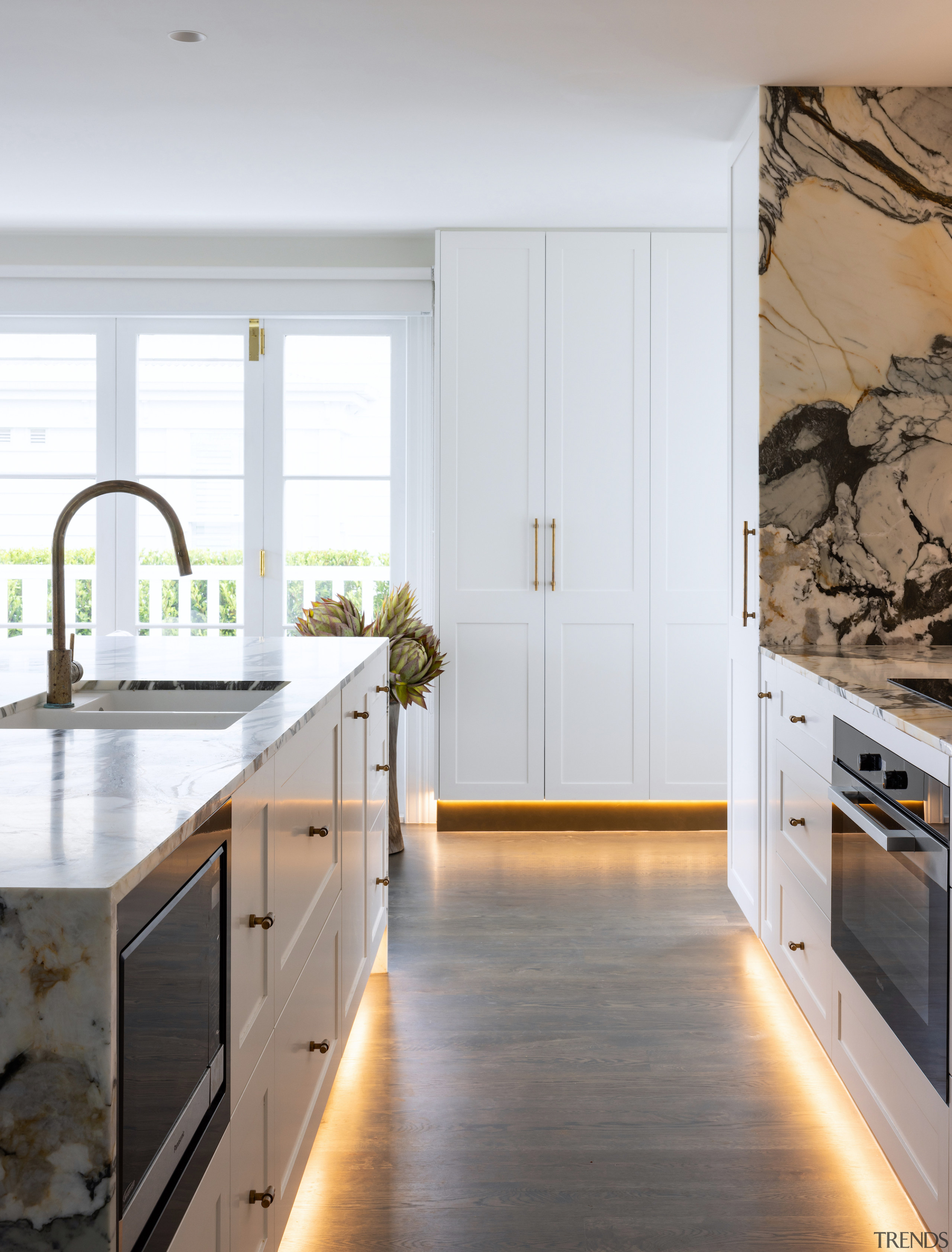 Metalier brass toekicks are highlighted by the concealed 