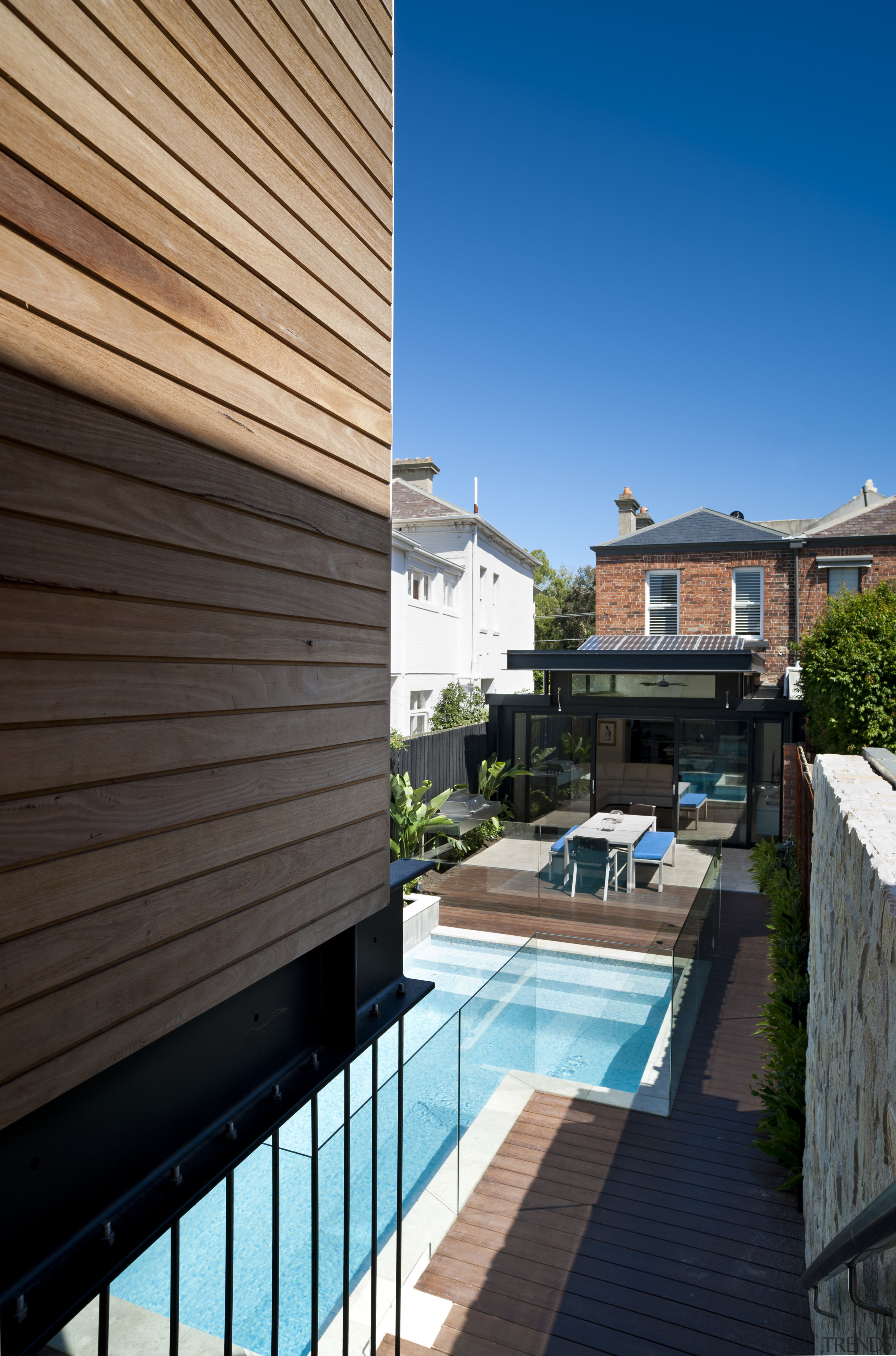 View down stairs to pool and patio area. apartment, architecture, backyard, balcony, condominium, daylighting, estate, facade, home, house, outdoor structure, property, real estate, residential area, roof, siding, swimming pool, villa, black