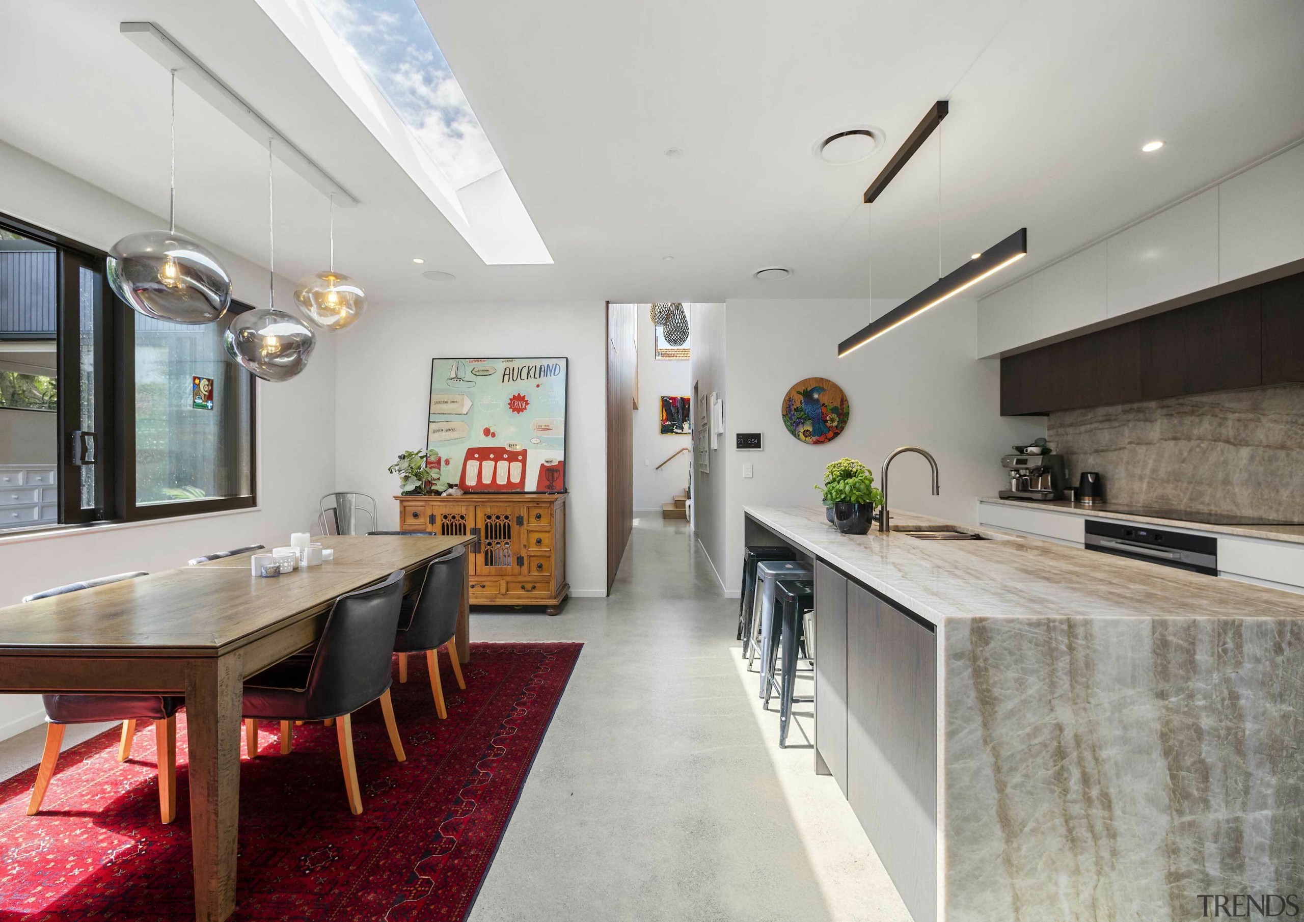 A stone waterfall benchtop matches the splashback in 