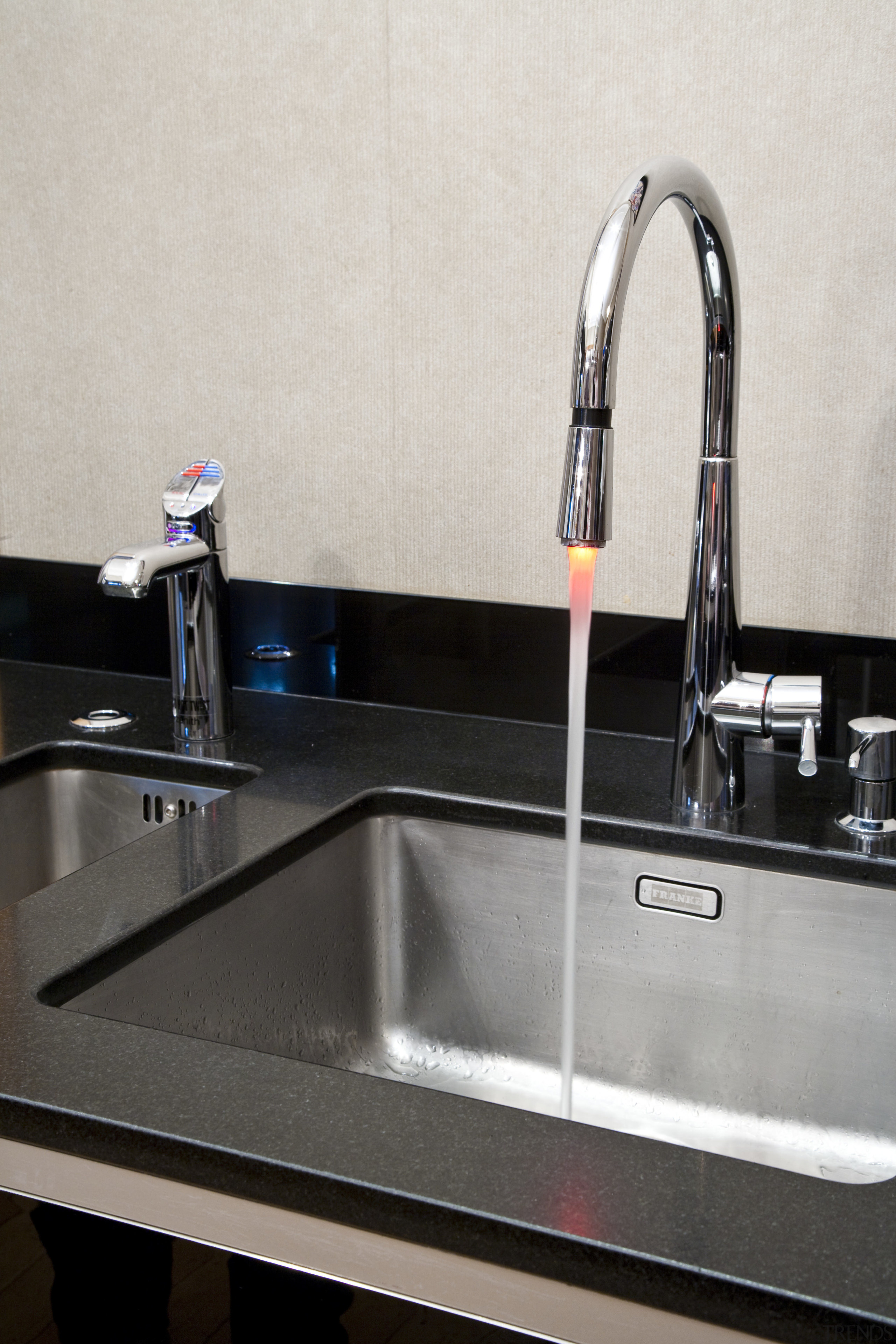 View of contemporary kitchen with dark cabinets and bathroom sink, countertop, plumbing fixture, product design, sink, tap, white, black