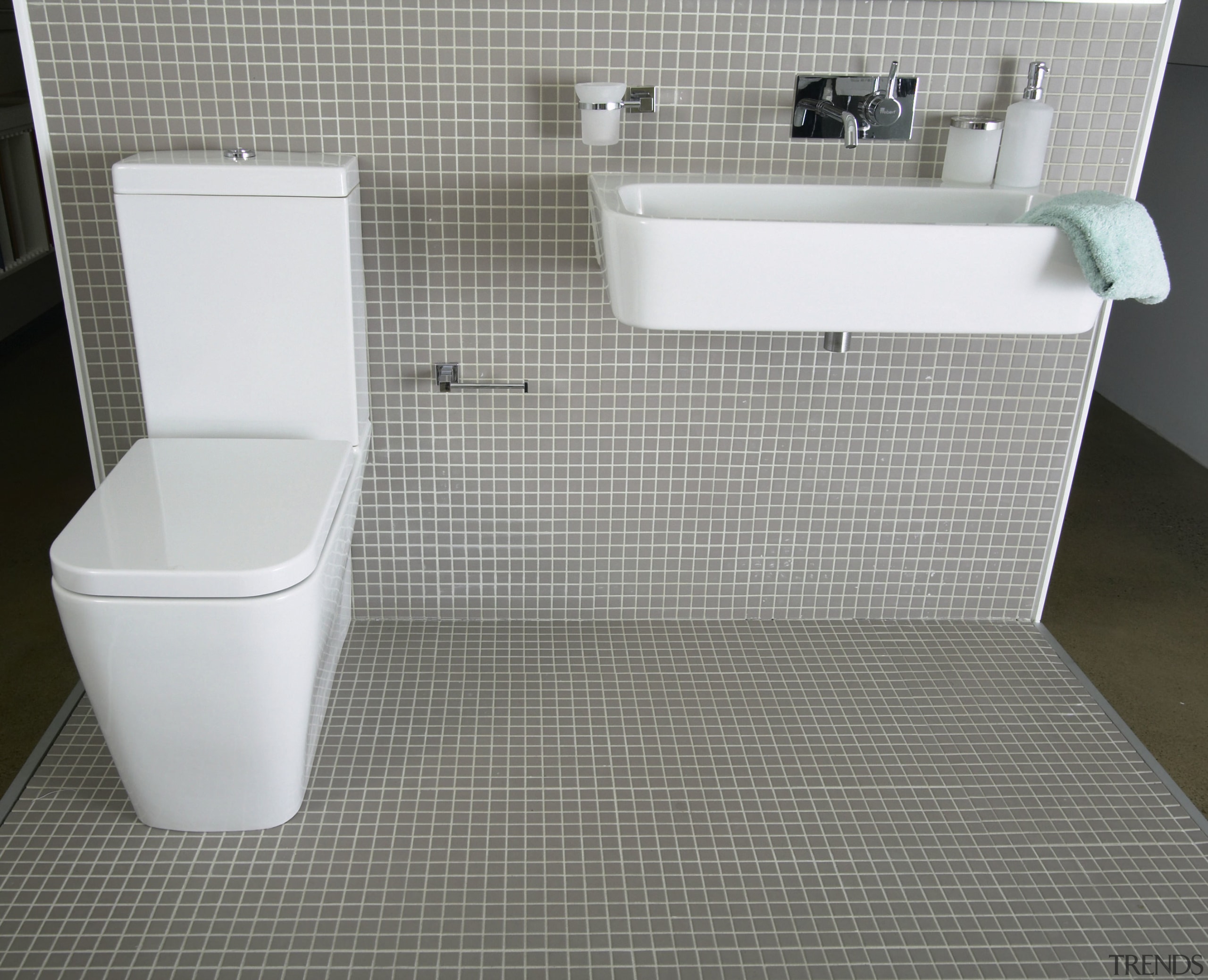 view of the bathroom featuring tiled walls, kohler bathroom, bidet, ceramic, floor, flooring, plumbing fixture, product, product design, tile, toilet, toilet seat, gray