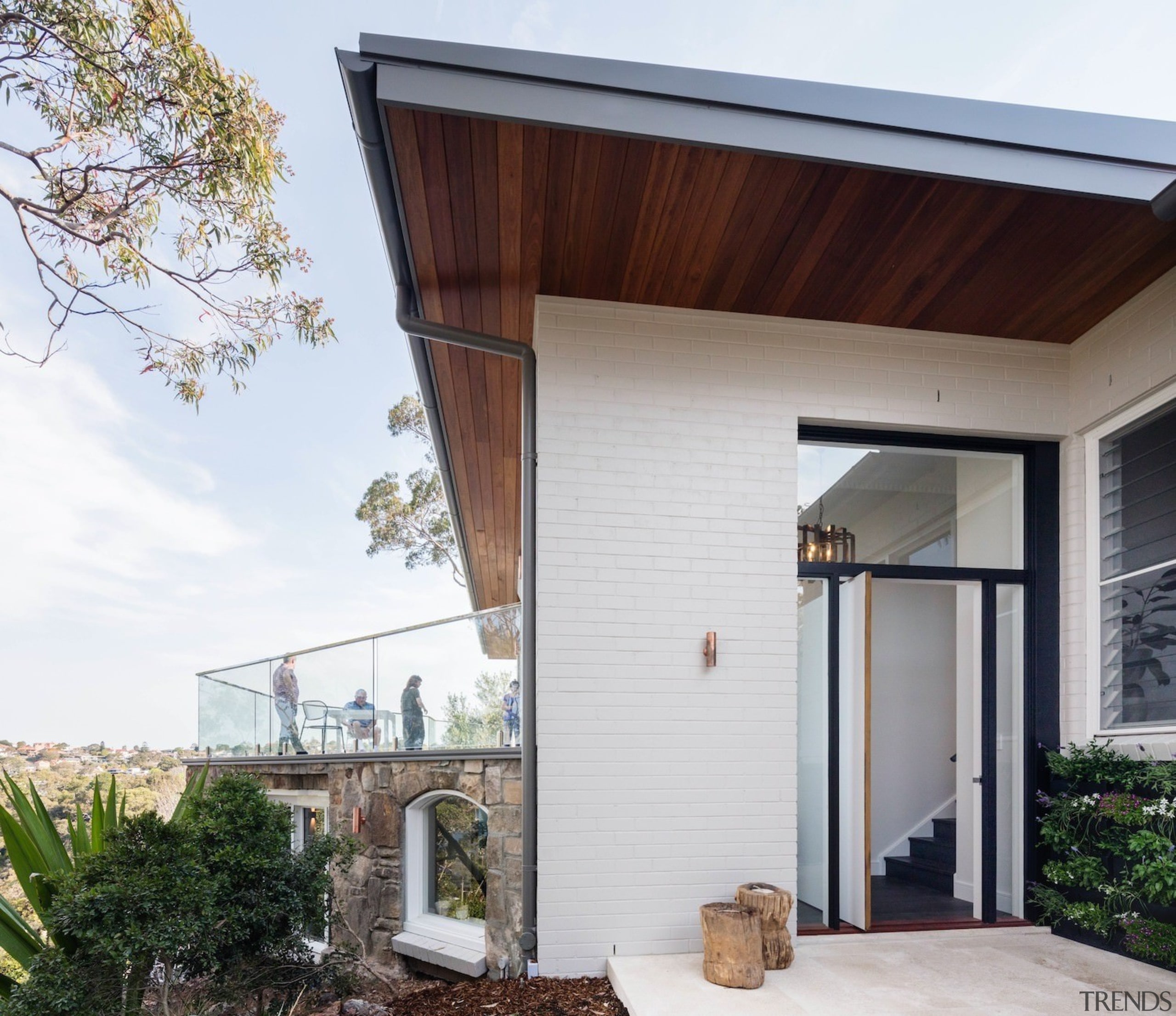 A stained wood soffit runs along outside the architecture, door, facade, home, house, porch, property, real estate, residential area, roof, siding, white, gray