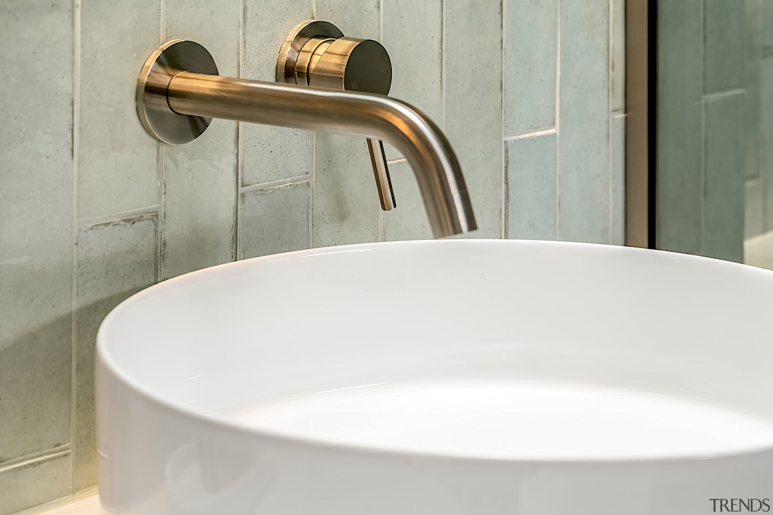 Table top basin meets wall-mounted, bronze-look tapware. 