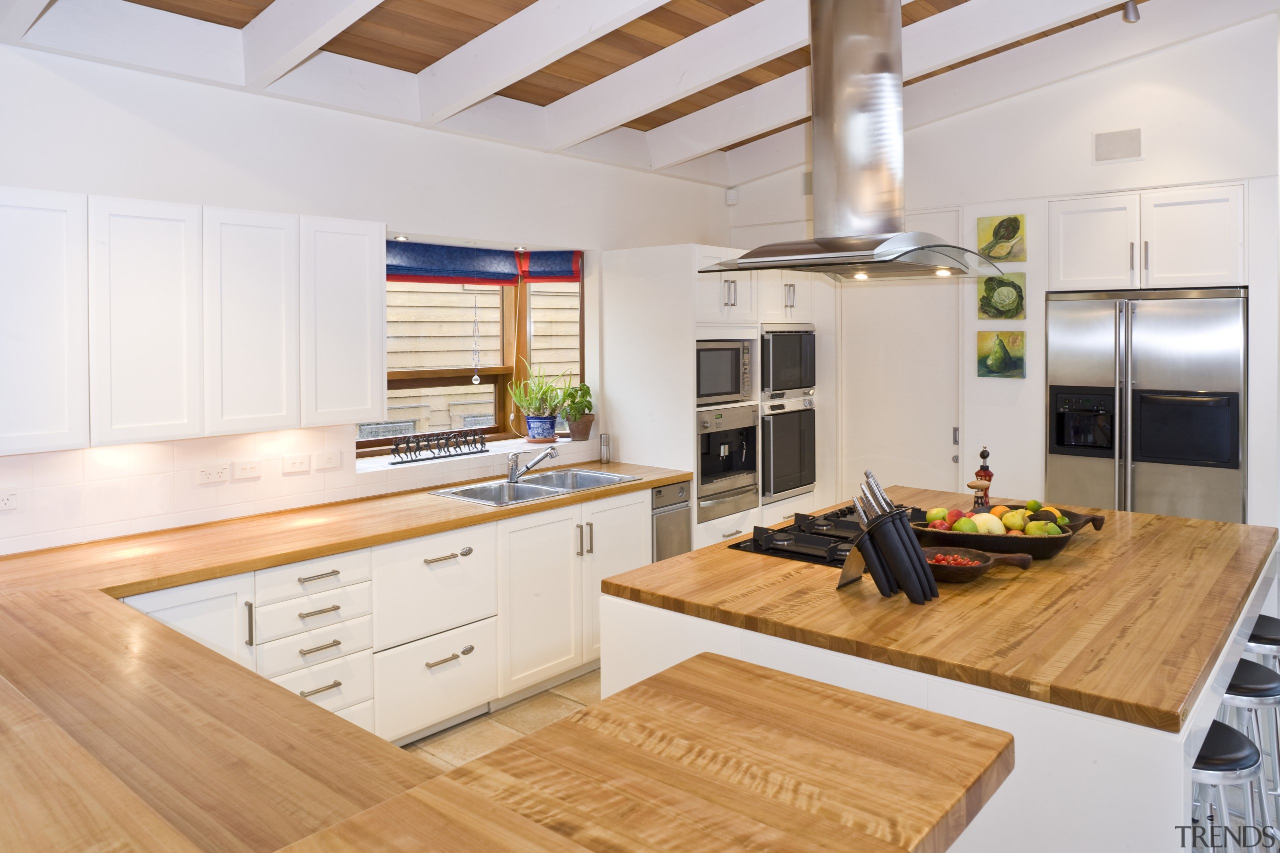 View of the kitchen which features an island countertop, interior design, kitchen, real estate, white, orange