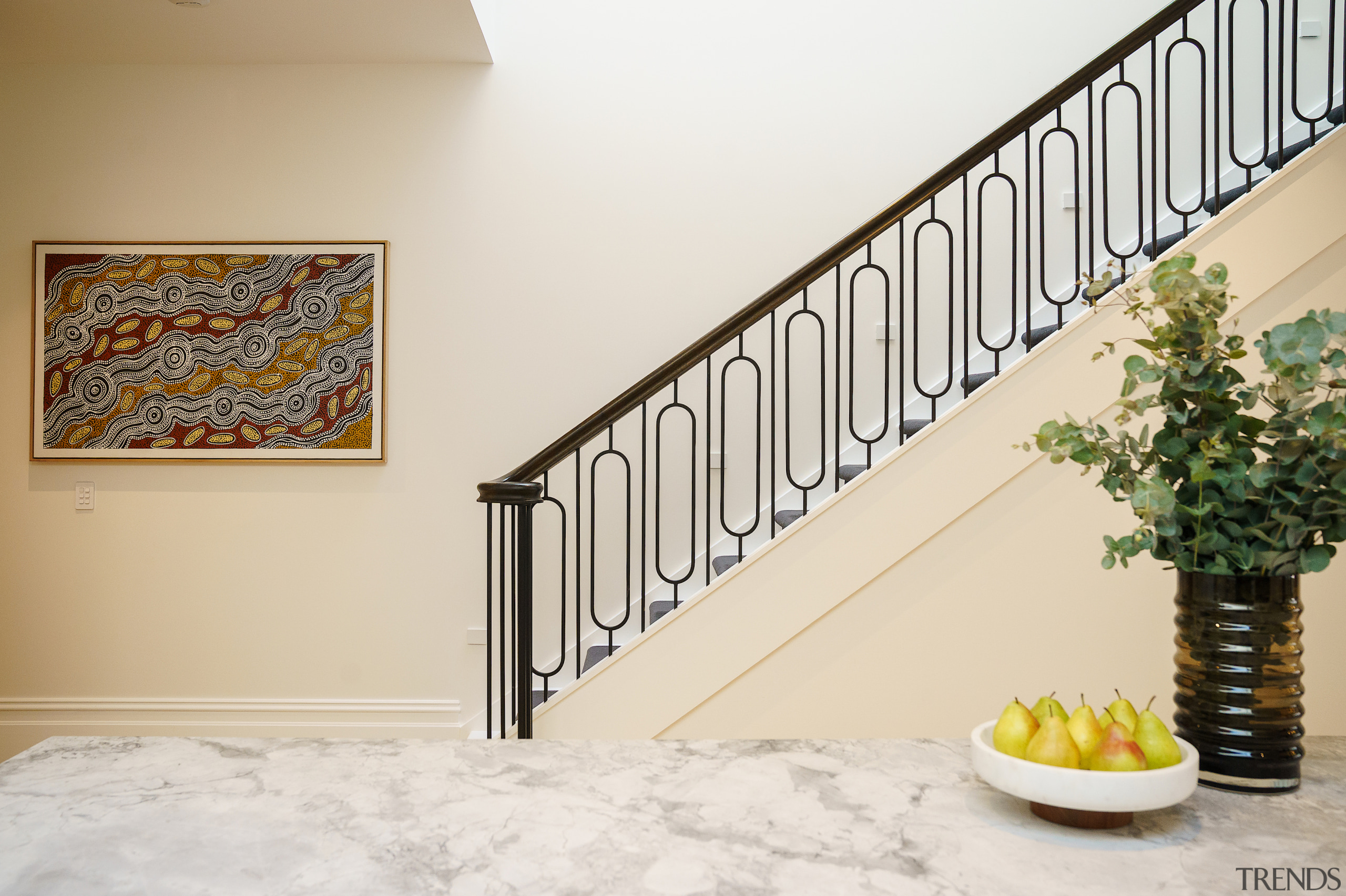 The bespoke staircase, positioned centrally, features a sleek 