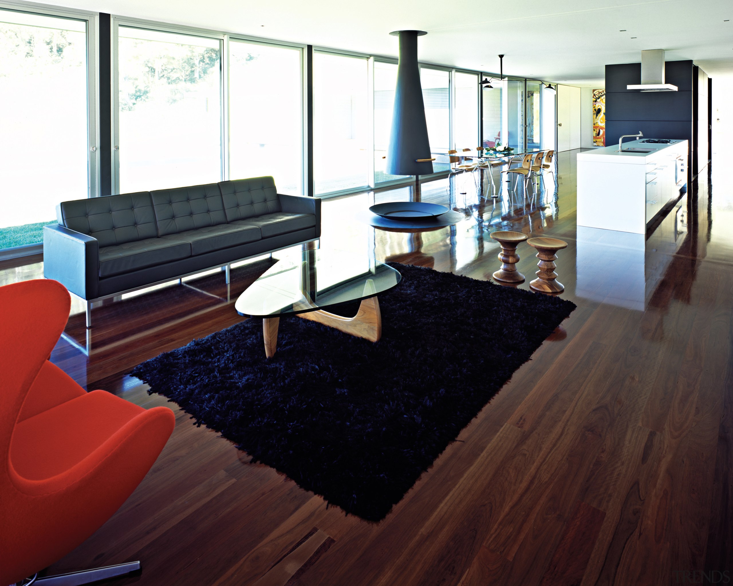 A view of the interior licing areas featuring floor, flooring, furniture, hardwood, interior design, laminate flooring, living room, real estate, room, table, wood, wood flooring, white, red