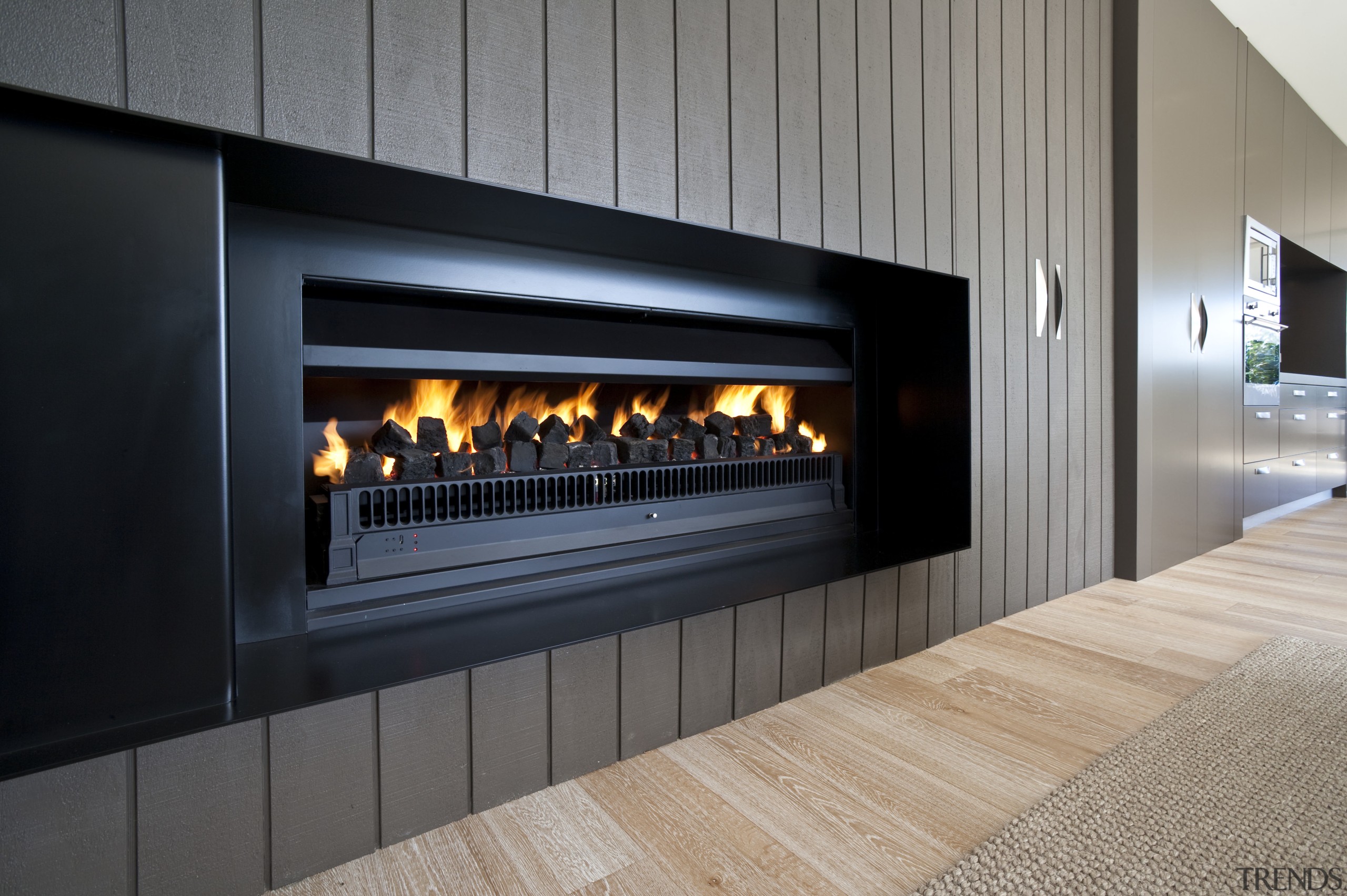 View of a living area which features a fireplace, hearth, gray, black