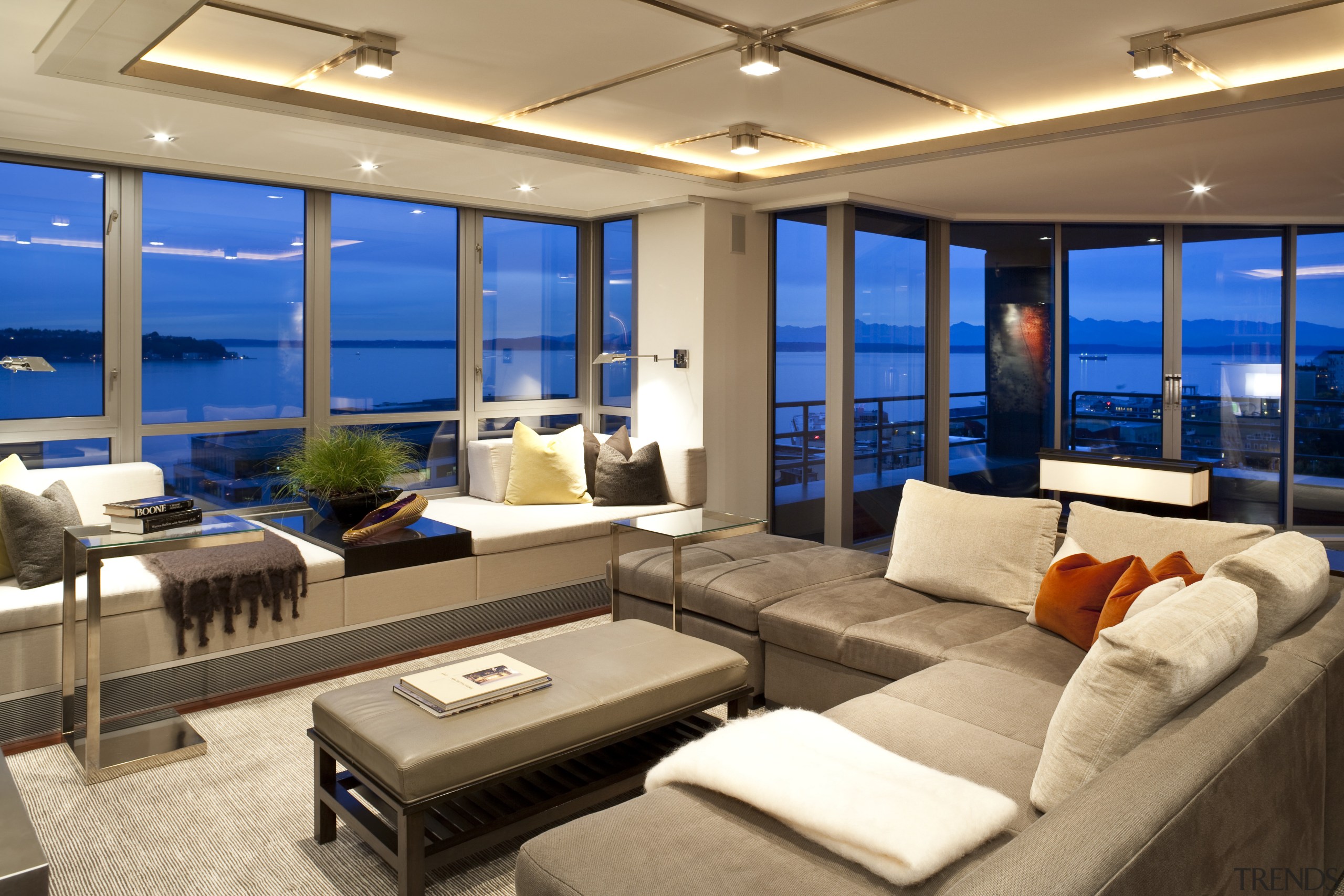 View of living space featuring rosewood flooring, customized ceiling, interior design, living room, penthouse apartment, real estate, orange, brown
