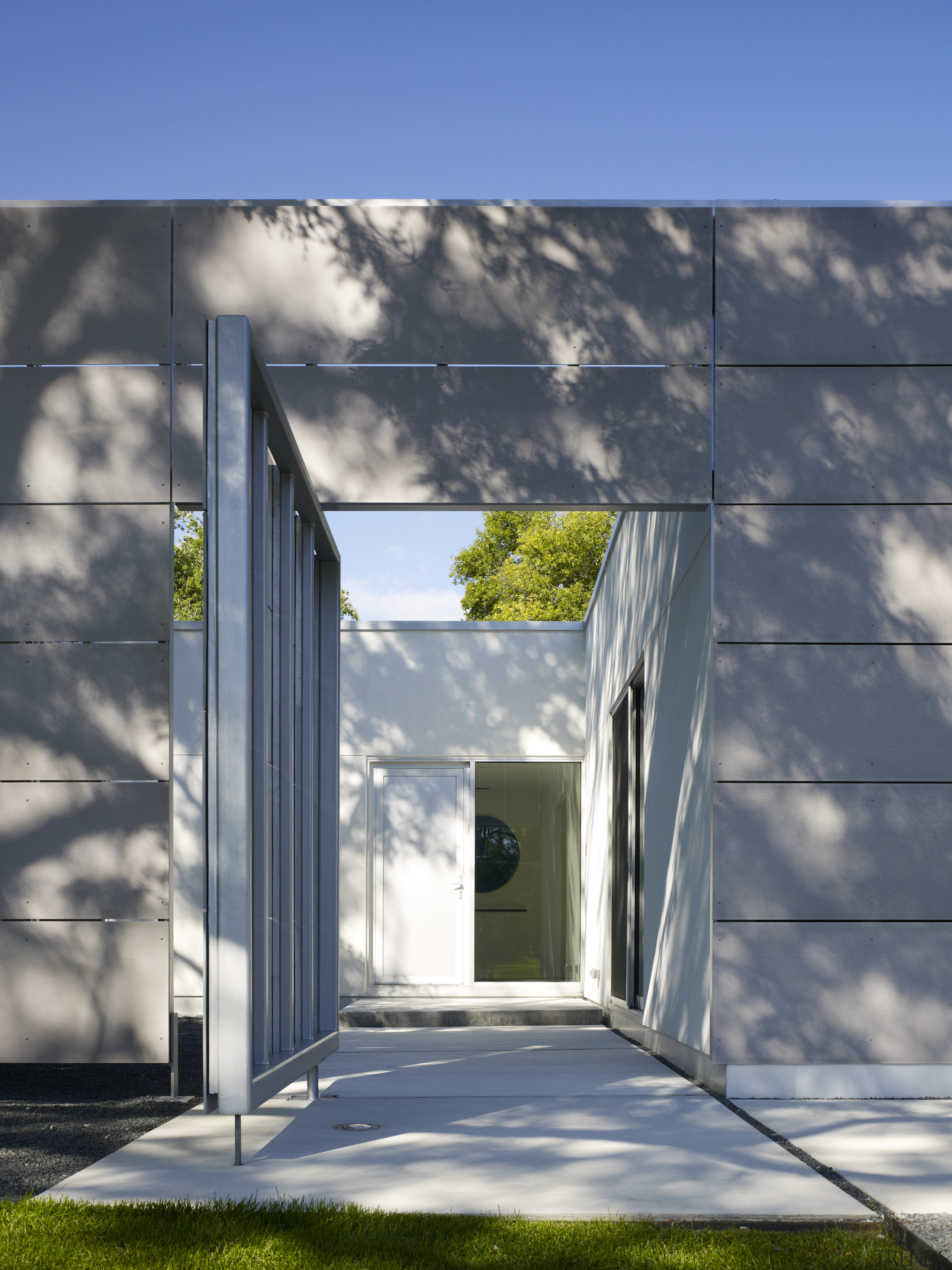 This door leads to an entry courtyard featuring architecture, building, daylighting, facade, home, house, residential area, sky, gray