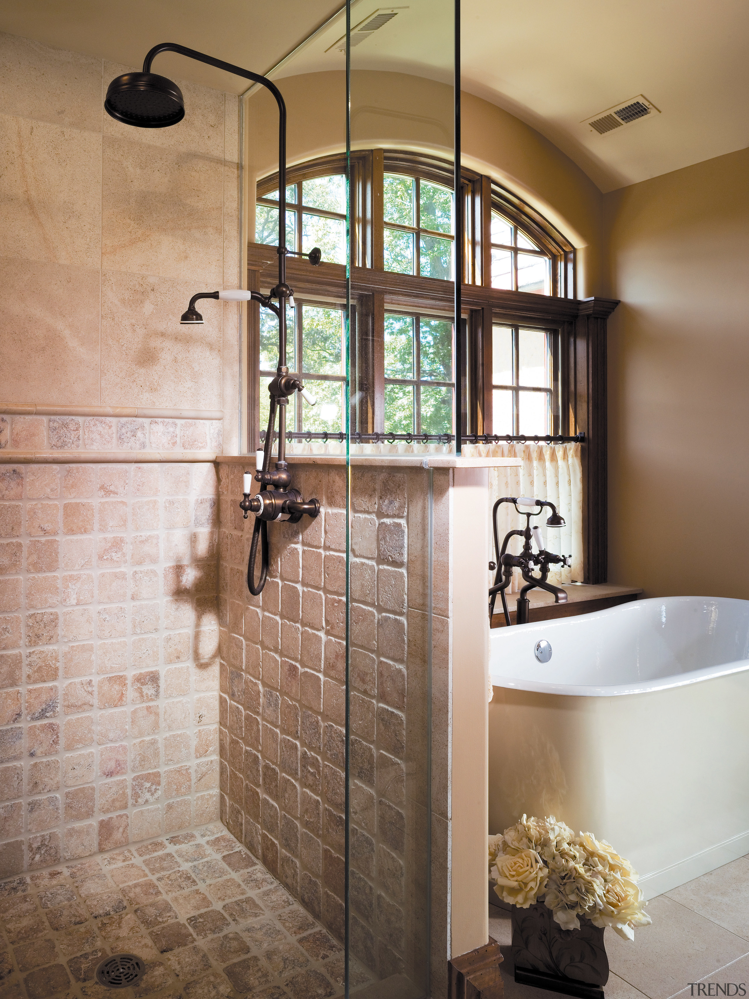 A close up view of the shower. - bathroom, floor, flooring, home, interior design, plumbing fixture, room, tile, wall, brown