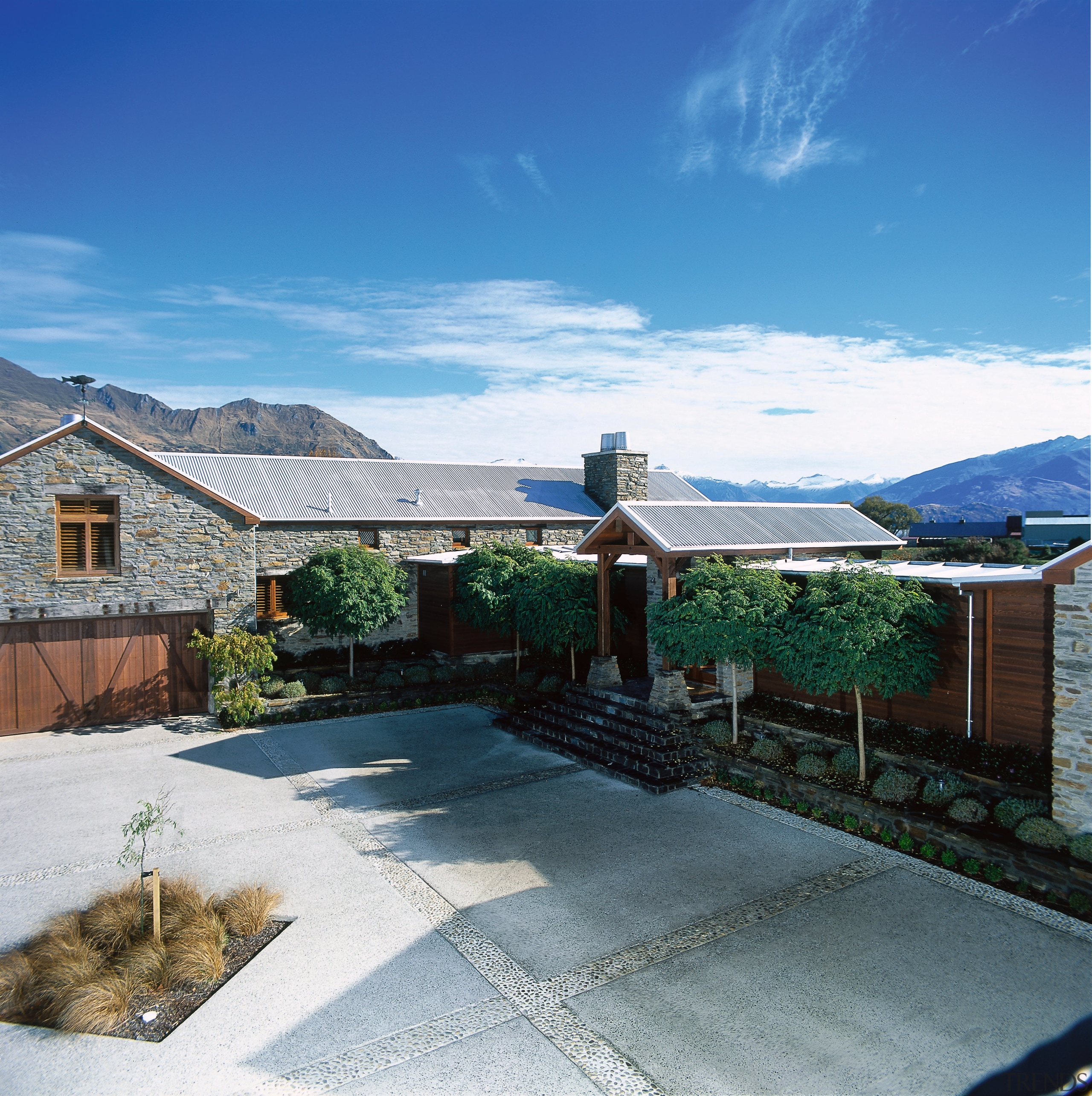 An exterior view of the house and concrete architecture, cloud, cottage, estate, home, house, landscape, mountain, outdoor structure, property, real estate, residential area, roof, sky, suburb, villa