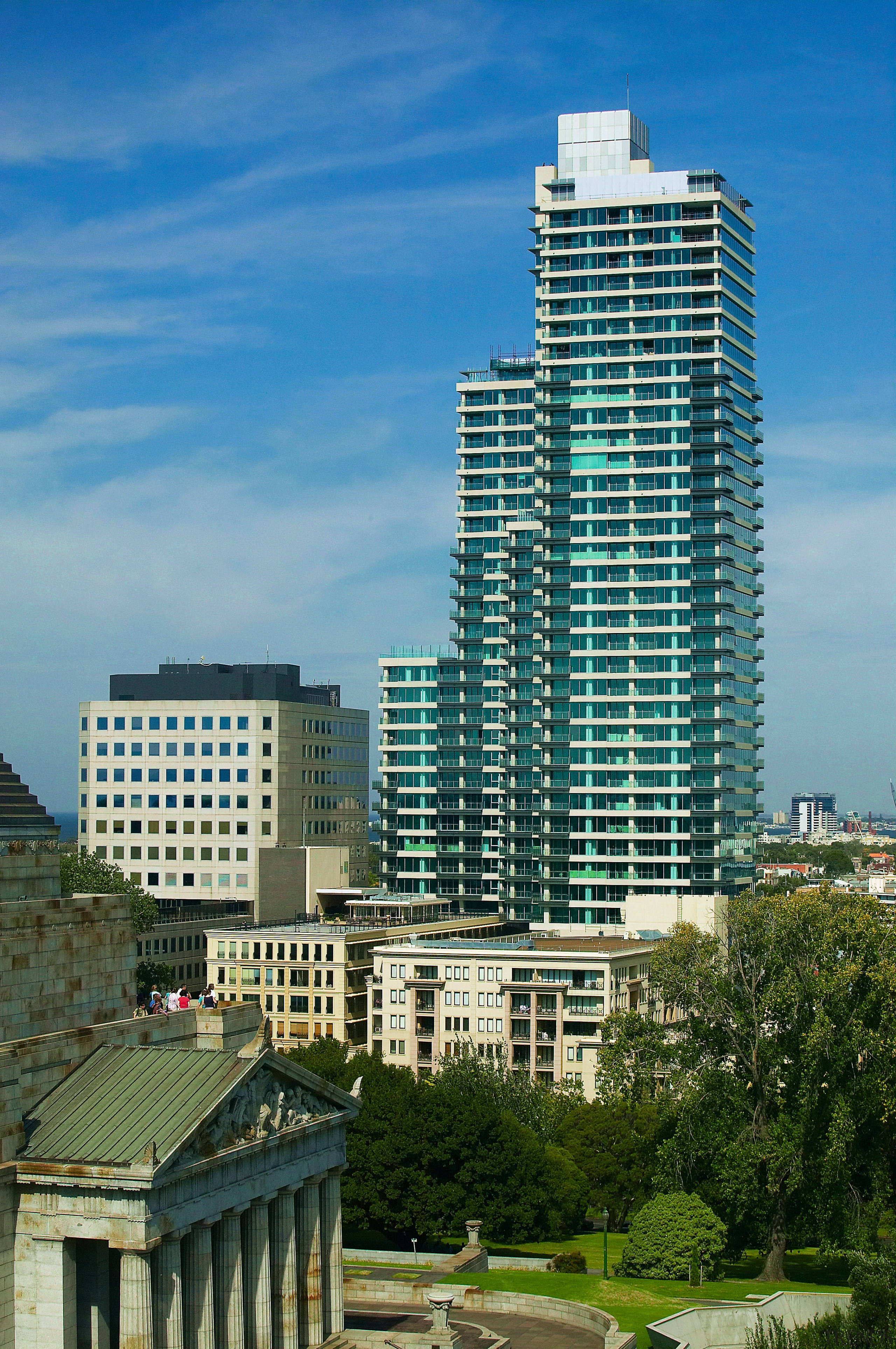A view of a Far East Consortium apartment apartment, architecture, building, city, cityscape, commercial building, condominium, corporate headquarters, daytime, downtown, estate, metropolis, metropolitan area, mixed use, neighbourhood, real estate, residential area, sky, skyline, skyscraper, suburb, tower, tower block, urban area, teal