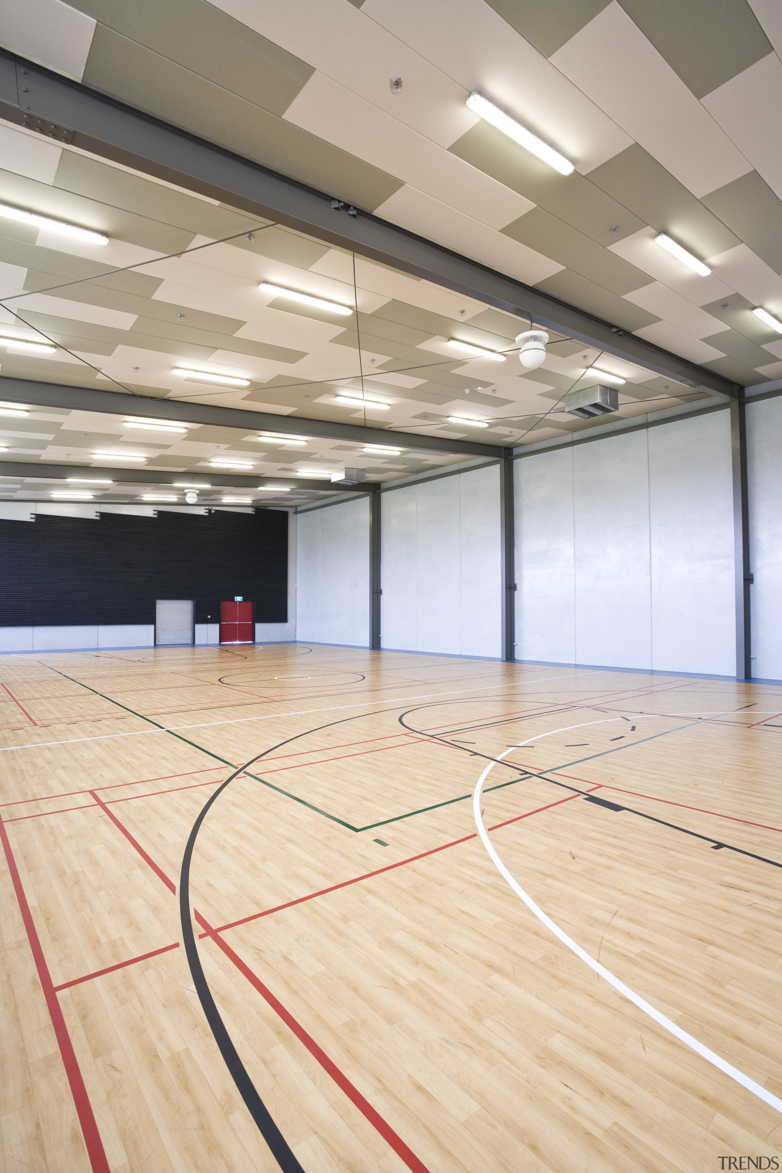 View of the Tupuranga School gymnasium which features basketball court, ceiling, floor, flooring, hall, hardwood, indoor games and sports, leisure centre, net, sport venue, sports, structure, wood, wood flooring, orange