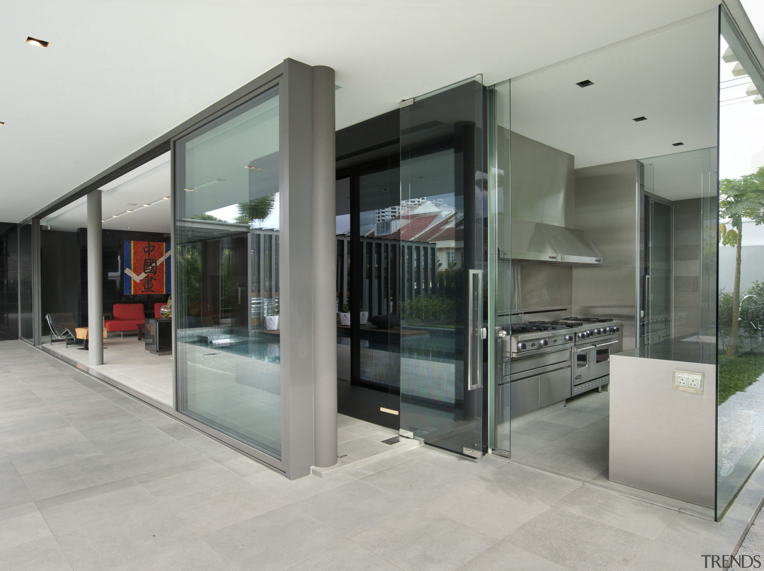 View of the wet kitchen which features stainless architecture, door, glass, house, real estate, gray