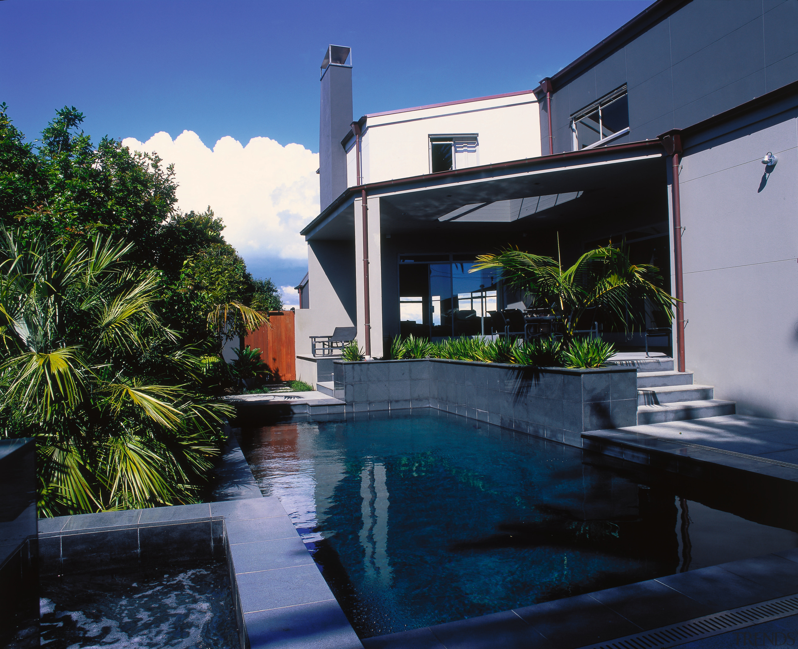 Black tiled spa pool looking over black swimming architecture, estate, home, house, property, real estate, reflection, residential area, sky, swimming pool, villa, water, blue, black