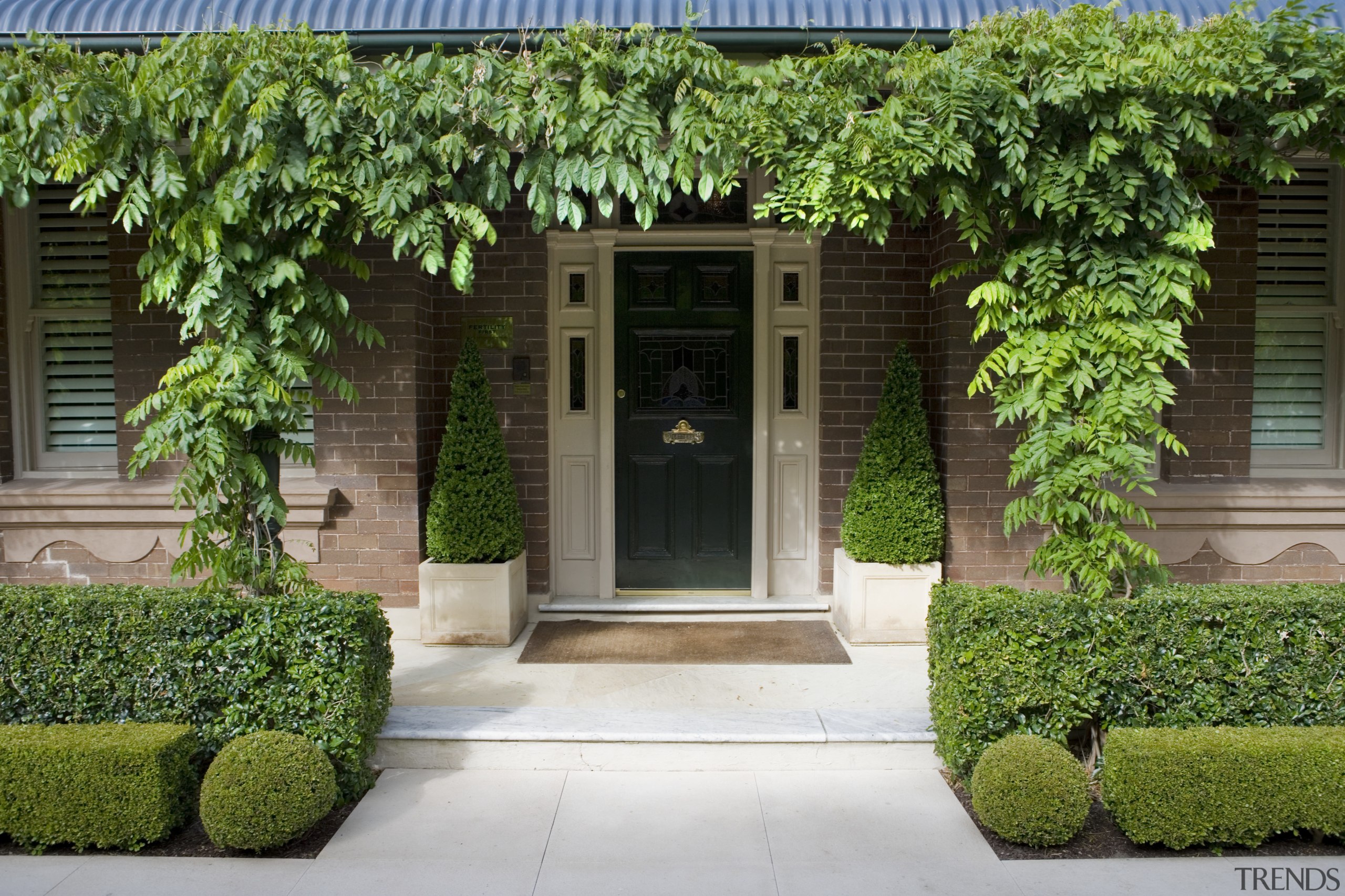 The front entrance of Fertility first is draped cottage, courtyard, door, estate, facade, garden, grass, home, house, plant, property, real estate, window, yard, green