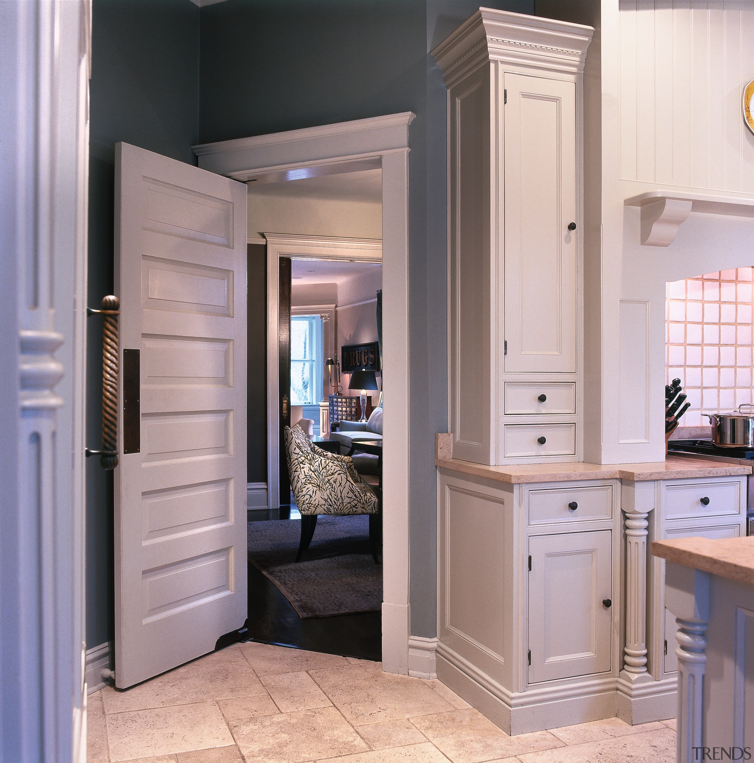 A view of this kitchen that features a bathroom accessory, bathroom cabinet, cabinetry, countertop, cuisine classique, floor, home, home appliance, interior design, kitchen, refrigerator, room, gray