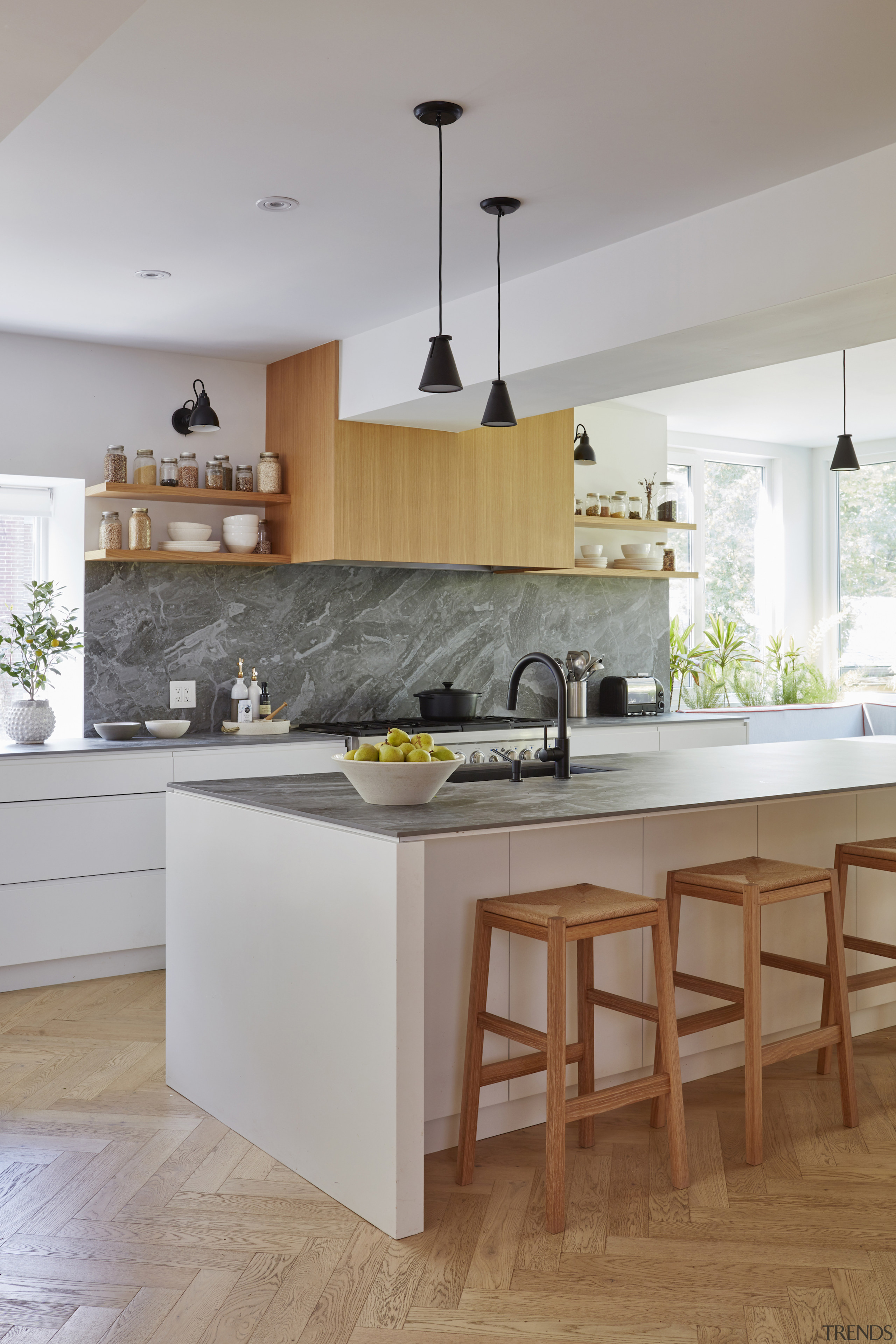 The wood cabinetry echoes the feature herringbone flooring. 