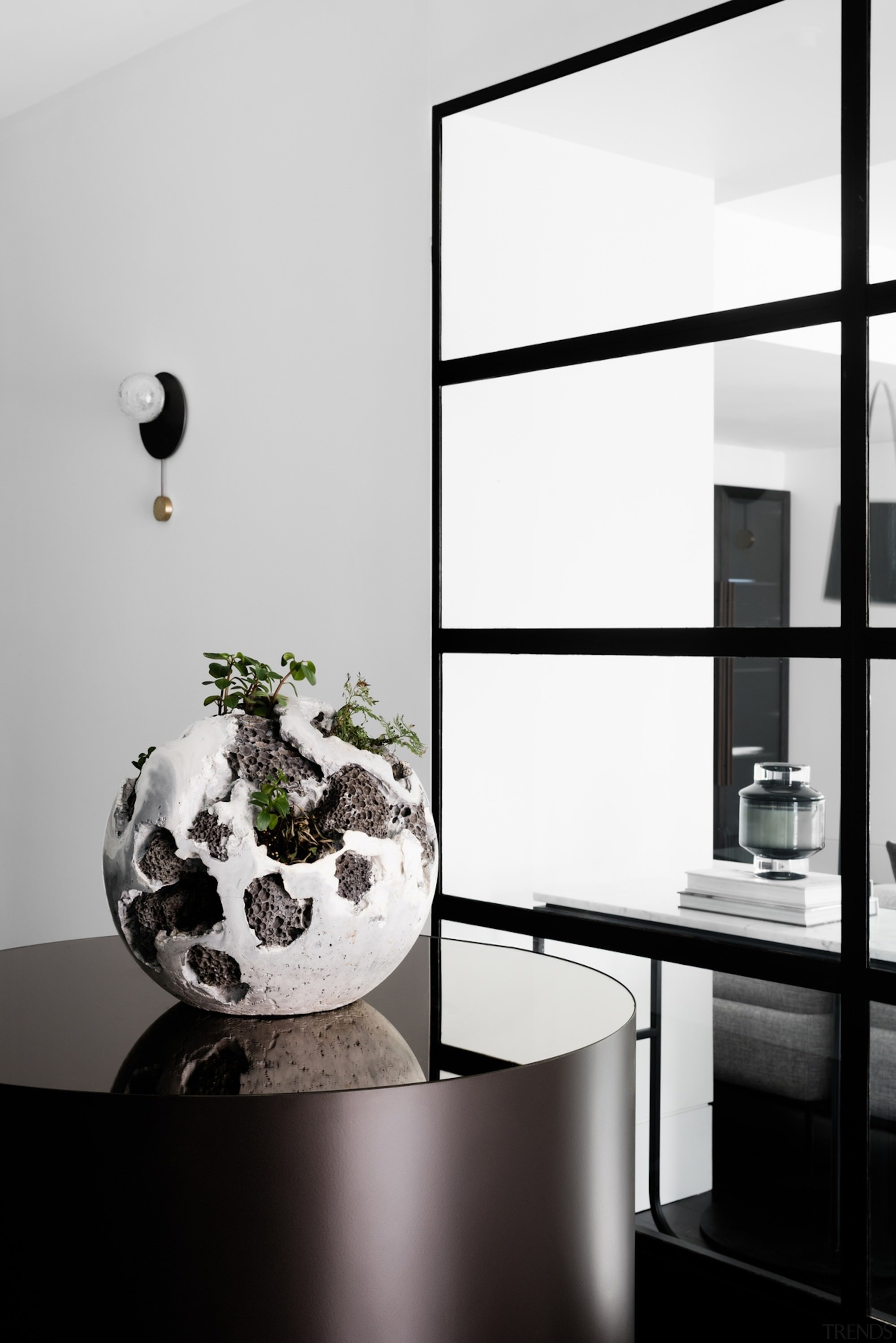 This centrepiece sits behind the living area - black and white, furniture, glass, interior design, lamp, light fixture, monochrome, monochrome photography, product design, table, tap, white, black