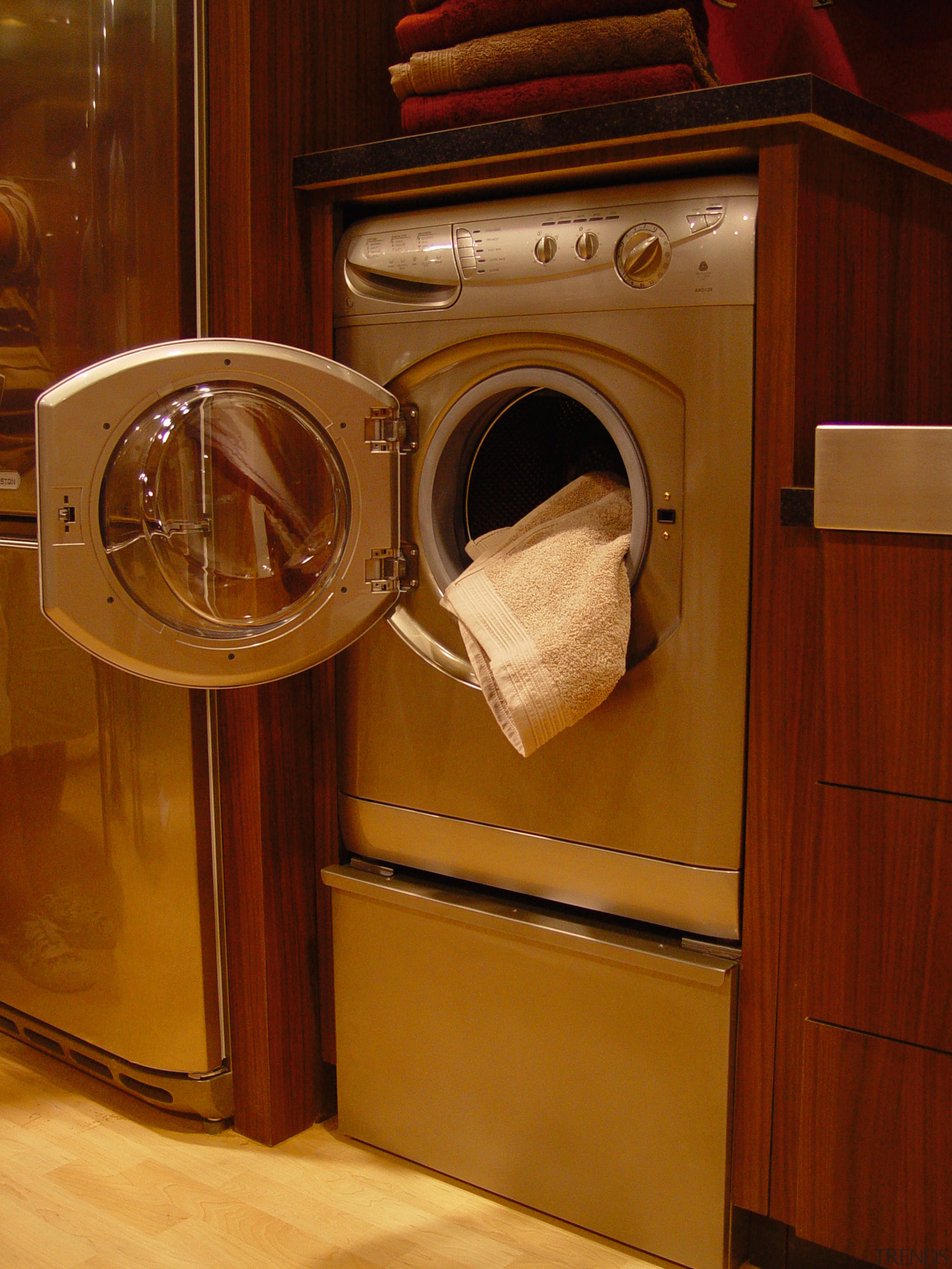 View of a silver clothes dryer in a cabinetry, furniture, home appliance, major appliance, room, washing machine, wood, brown