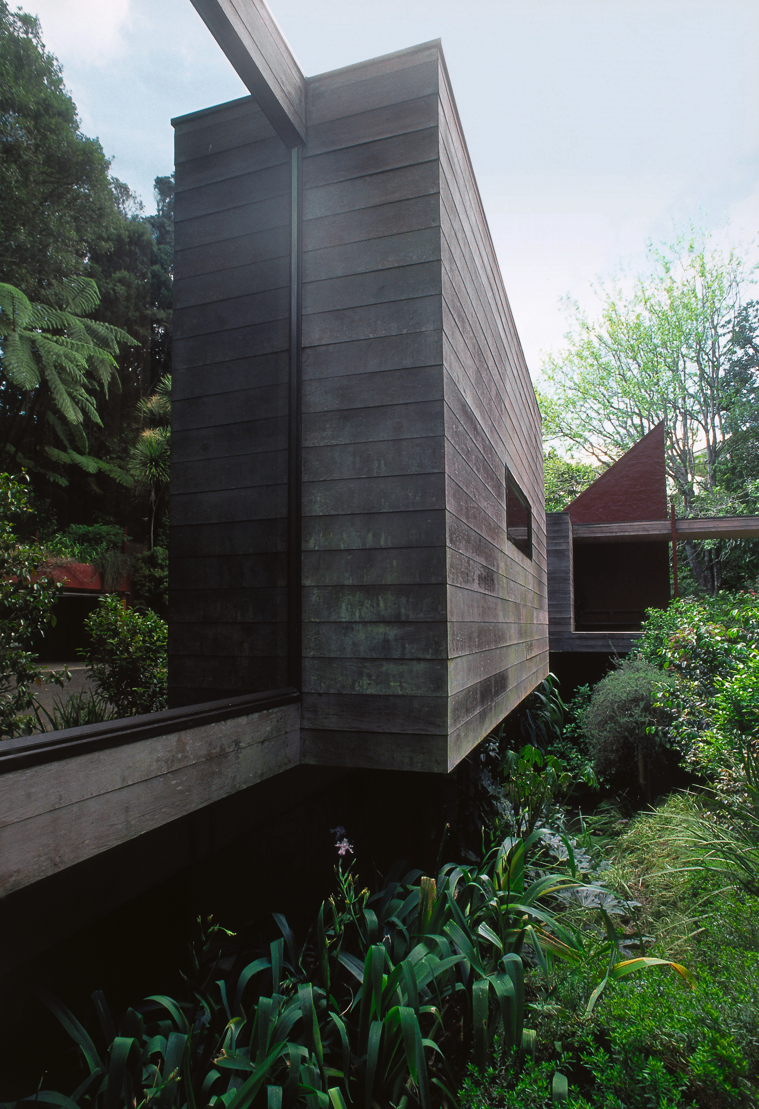 A view of this house designed by Ron architecture, building, facade, home, house, real estate, tree, black