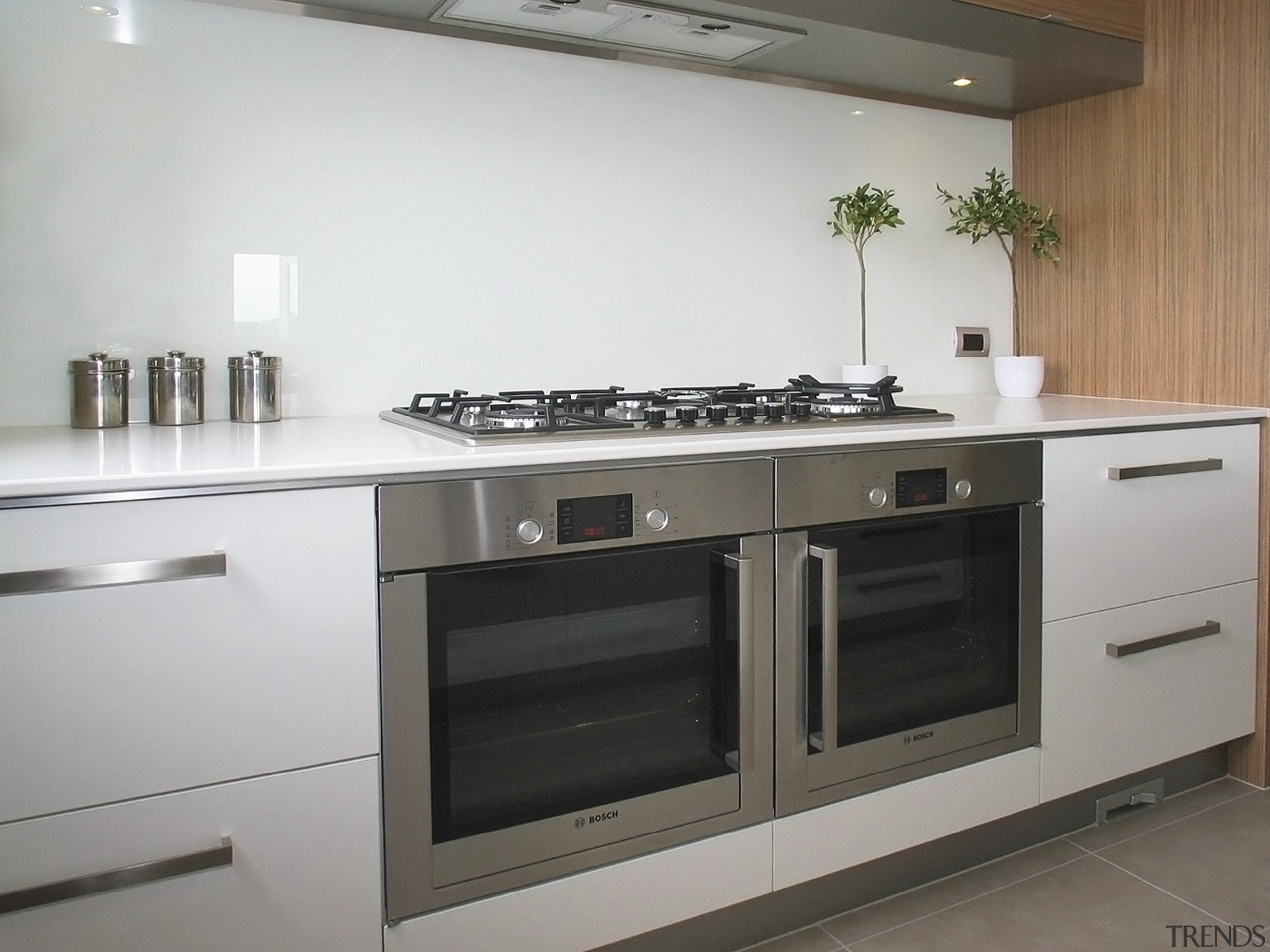 View of a kitchen which was designed by cabinetry, countertop, cuisine classique, gas stove, home appliance, kitchen, kitchen appliance, kitchen stove, major appliance, oven, gray