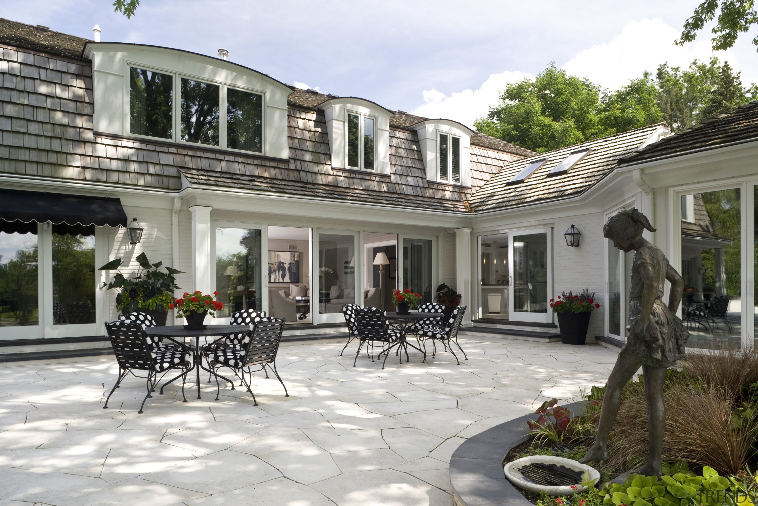 Image of the exterior of this home which backyard, courtyard, estate, home, house, outdoor structure, patio, property, real estate, window, gray, white