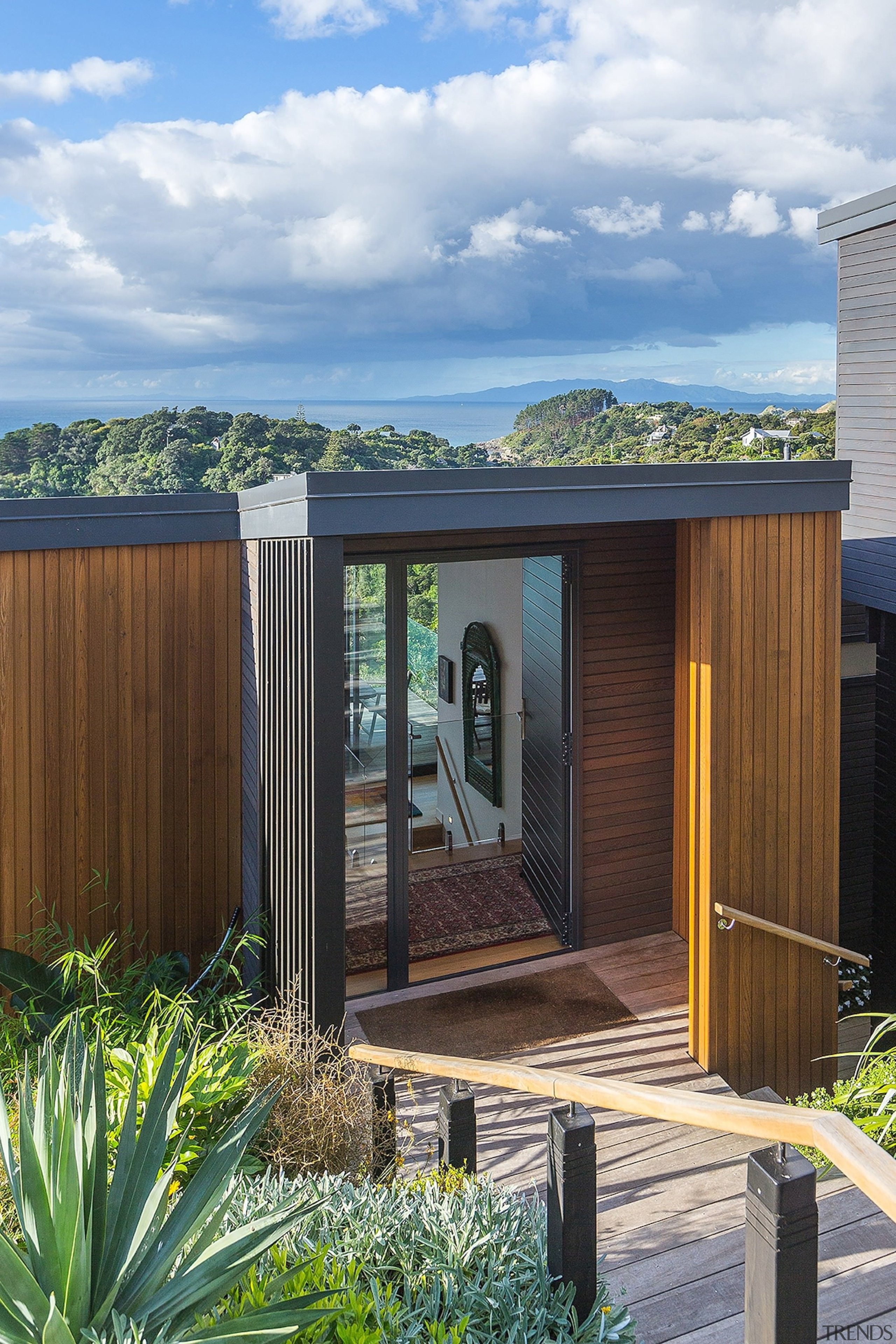 The entrance is understated – and sheltered - architecture, cottage, facade, home, house, outdoor structure, real estate, shed, wood