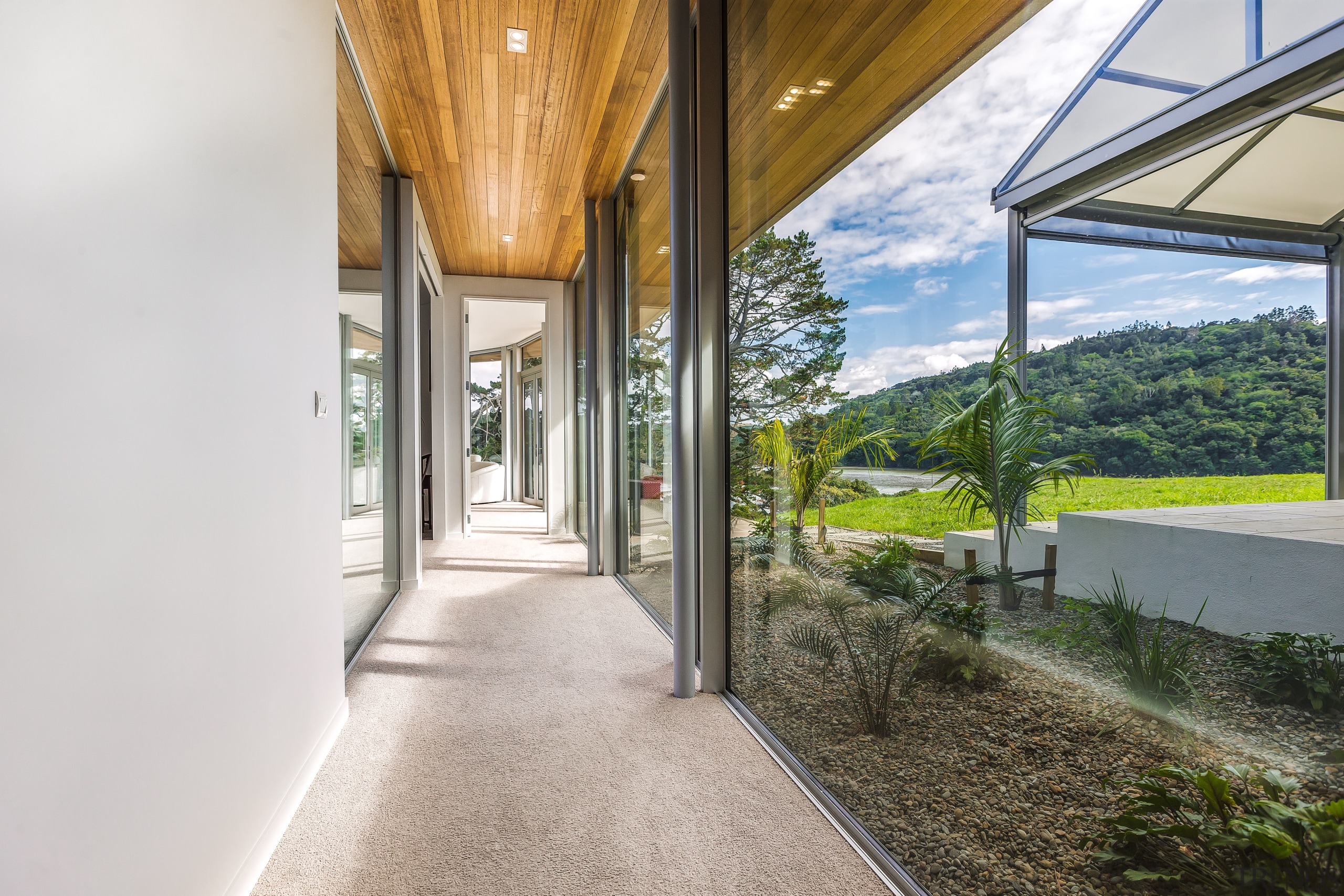 ​​​​​​​The glass connecting corridor on this two-wing addition white