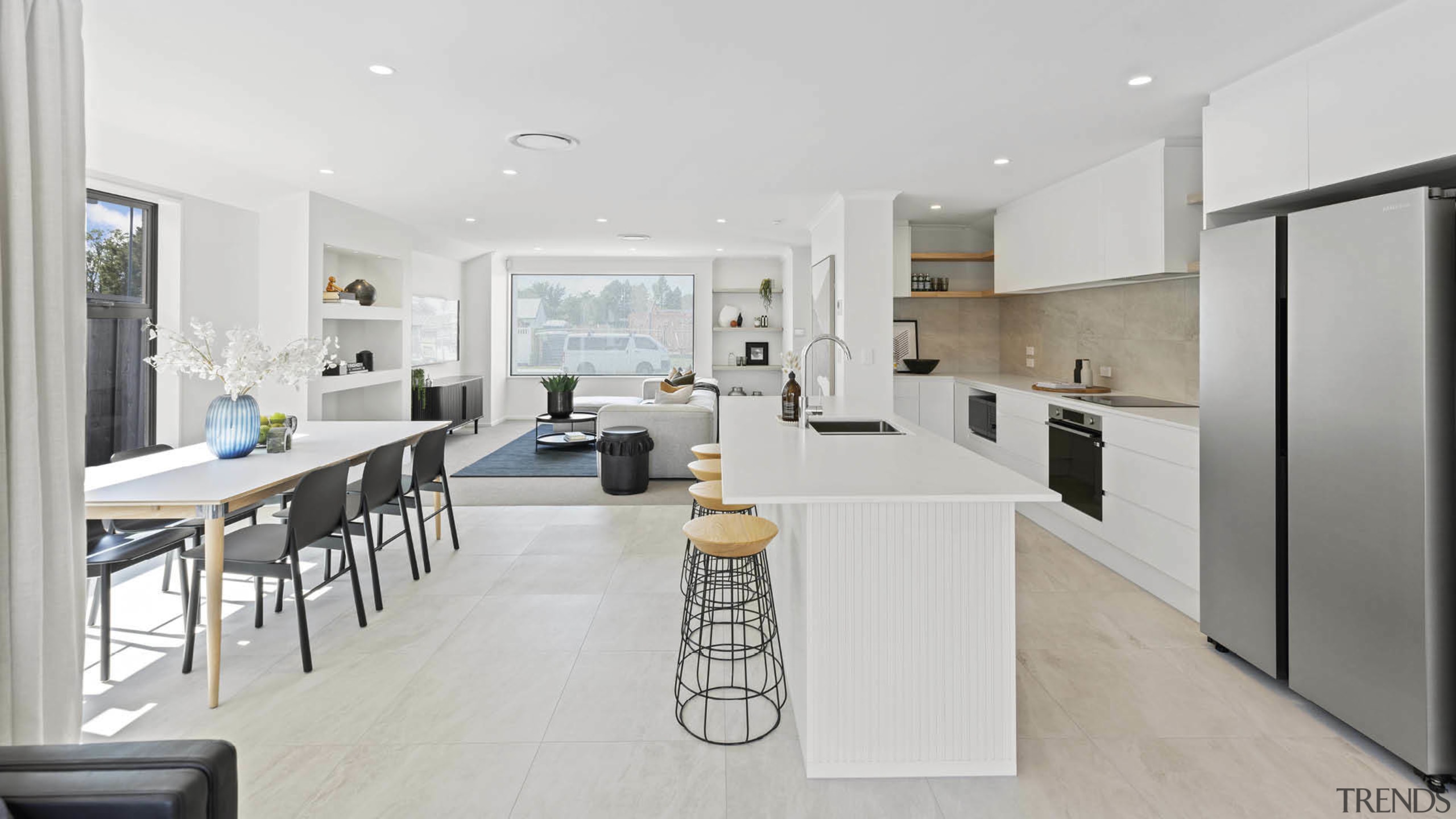 The expansive entertainment space is flooded with natural 