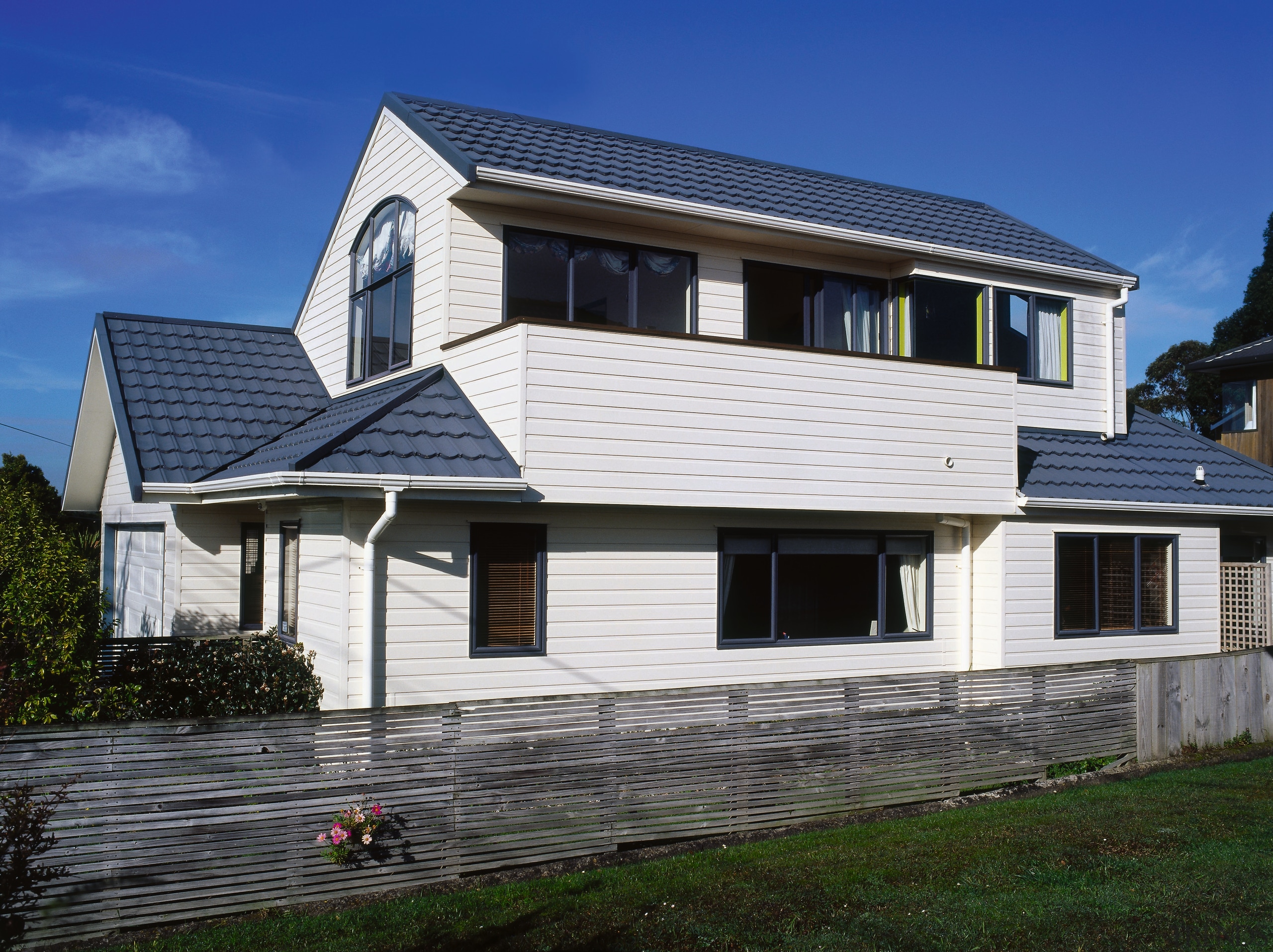 View of this modern home - View of building, cottage, elevation, facade, home, house, property, real estate, residential area, roof, siding, window, blue, black