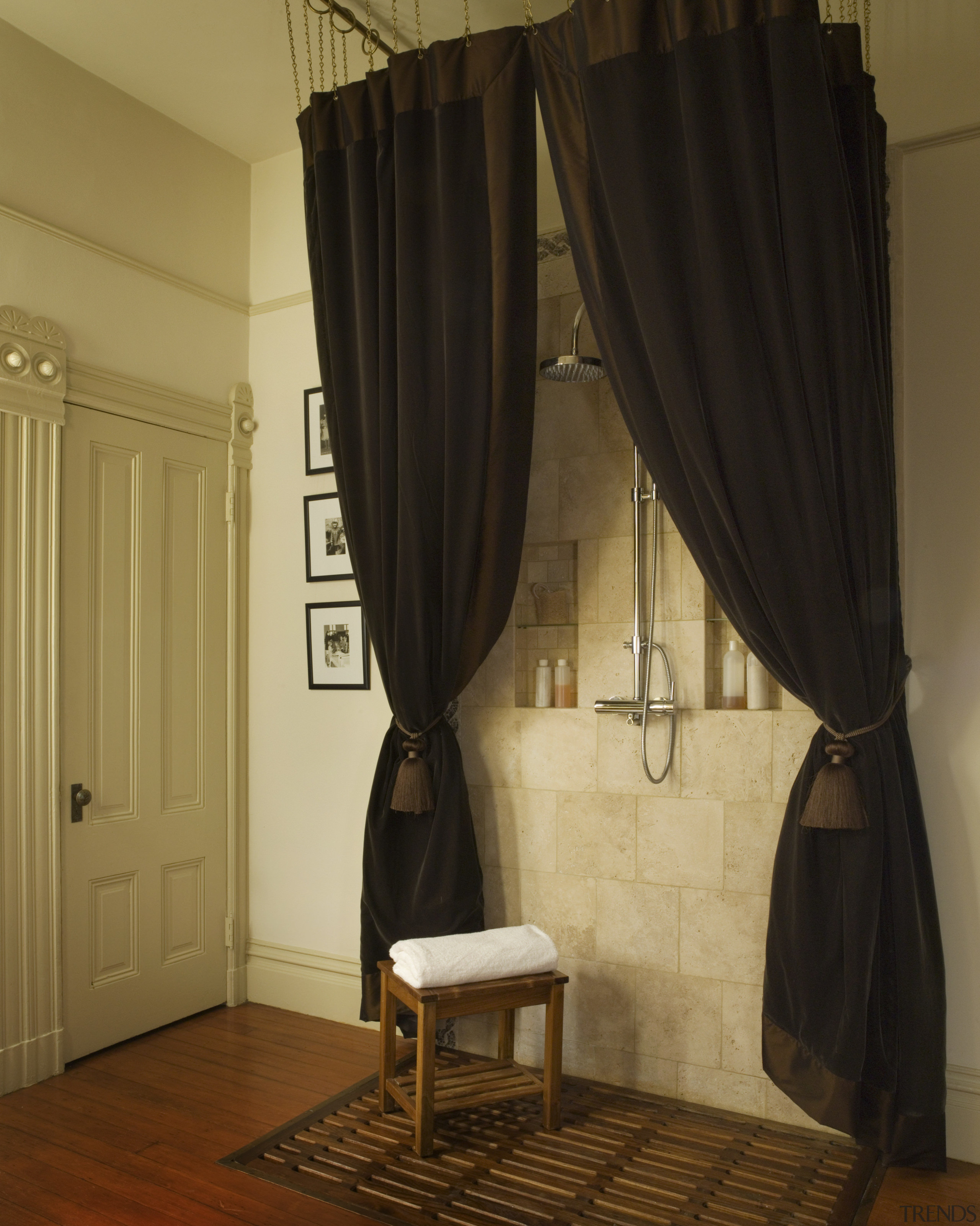 A view of this bathroom featuring polished timber ceiling, curtain, decor, floor, furniture, interior design, room, textile, window, window covering, window treatment, brown, black