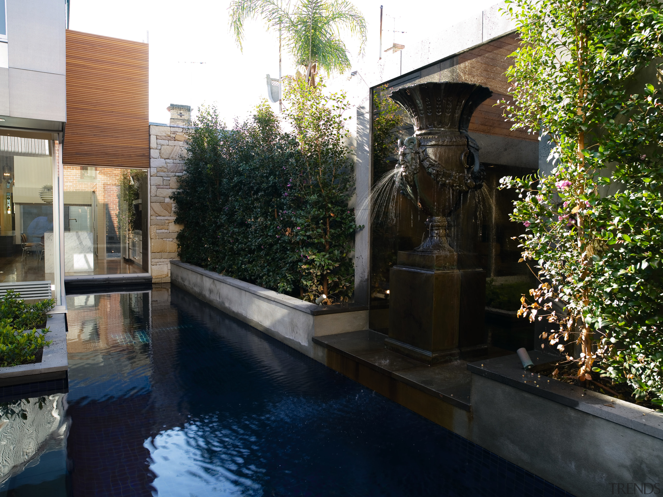 An exterior view of the water feature in reflecting pool, reflection, tree, water, water feature, black