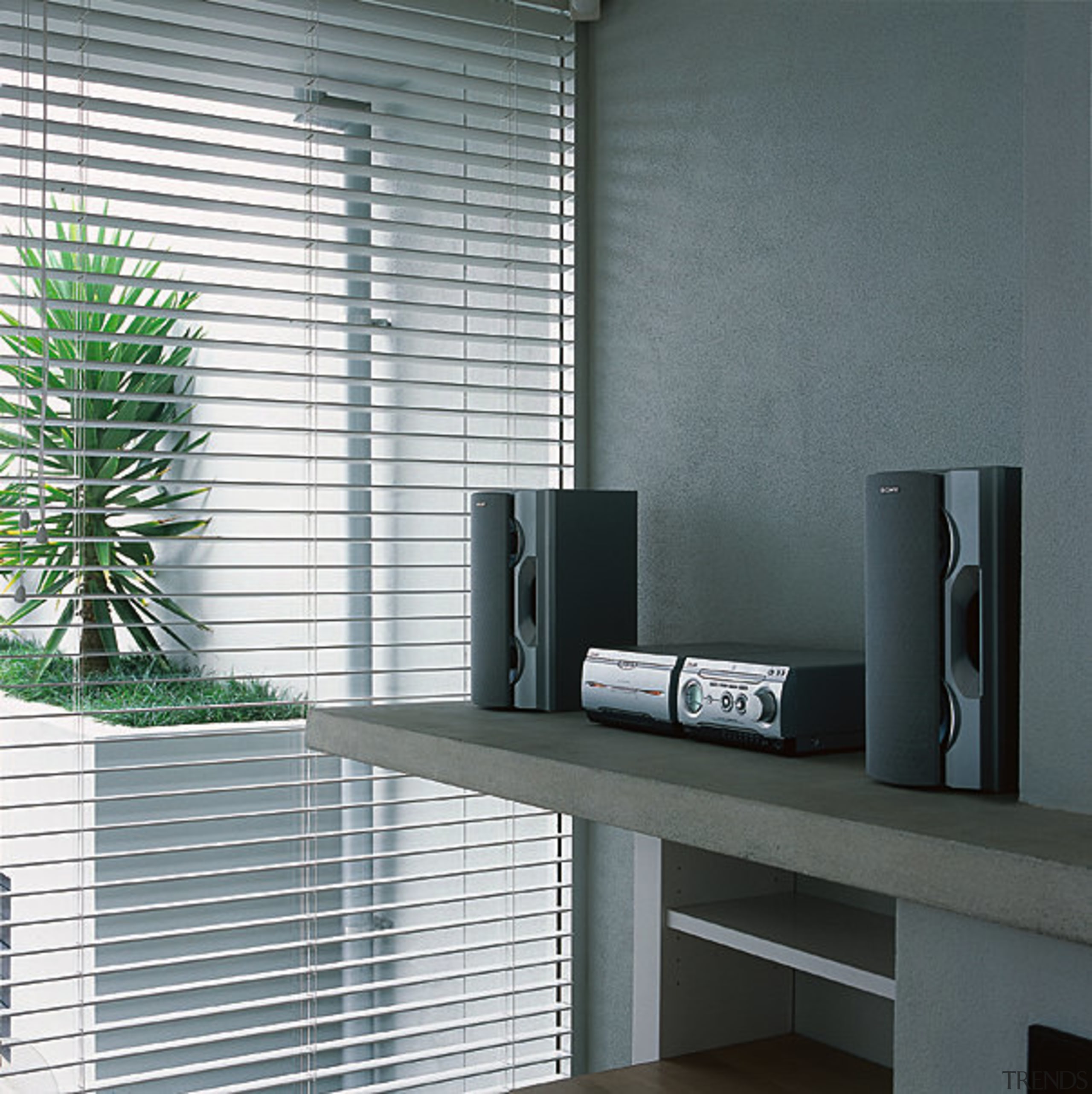 A photograph of a Sony two-box mini system furniture, glass, interior design, product design, shelf, shelving, wall, window, window blind, window covering, gray