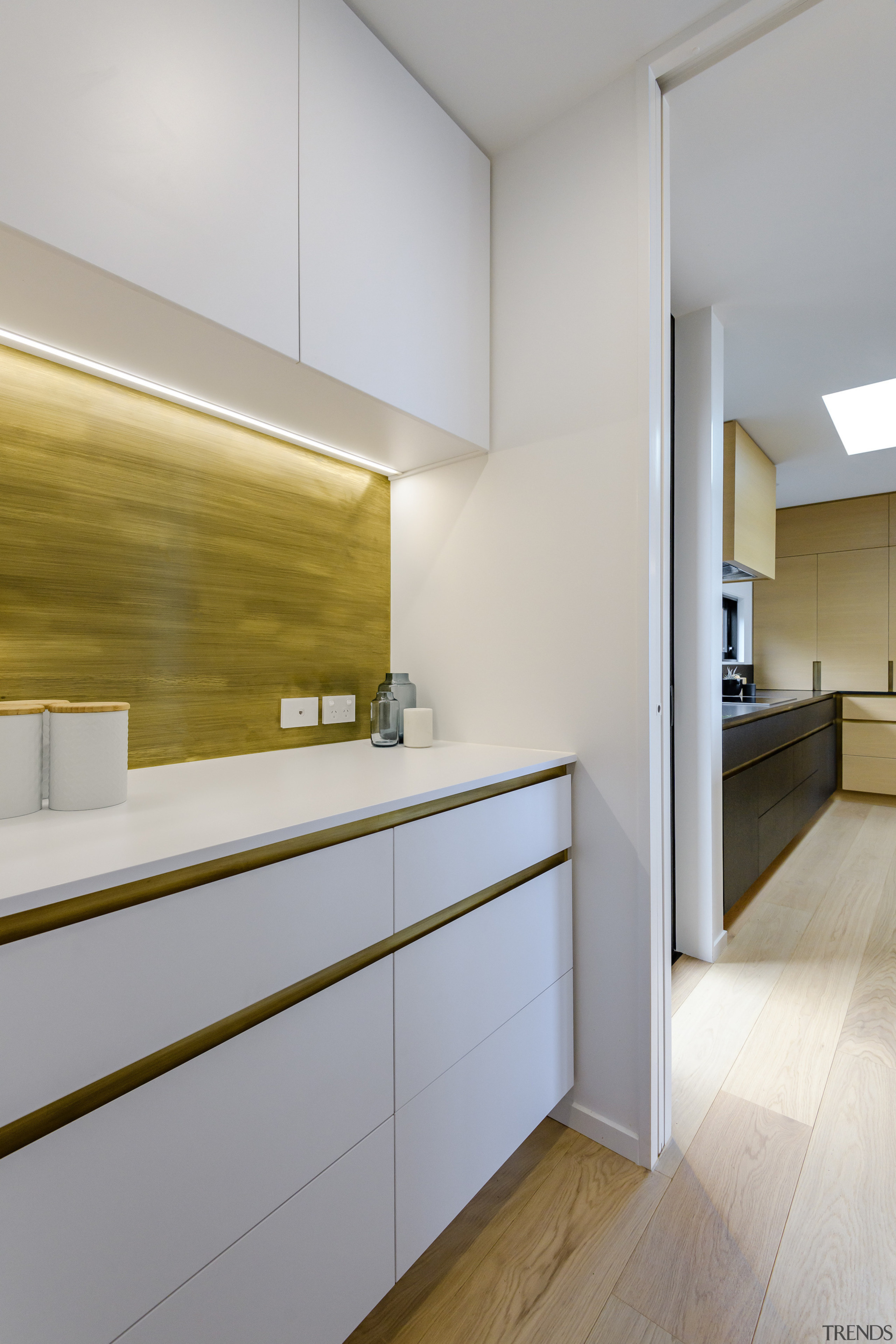 The pantry is in contrasting white cabinetry. 