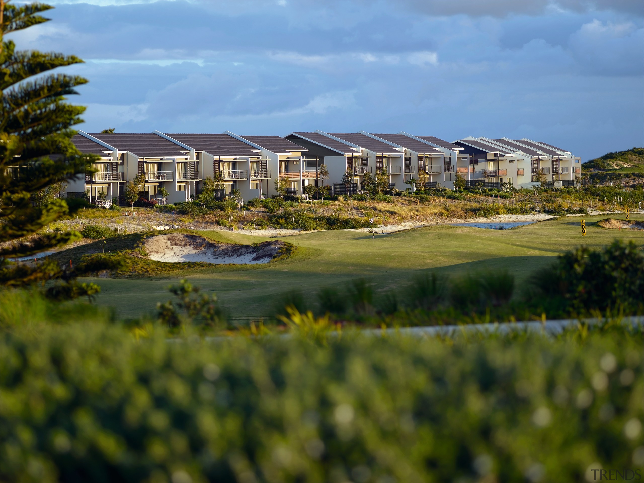 Ab exterior view of the Magenta shores holiday/residential estate, golf club, golf course, home, land lot, landscape, plantation, real estate, reflection, sky, water, brown, teal