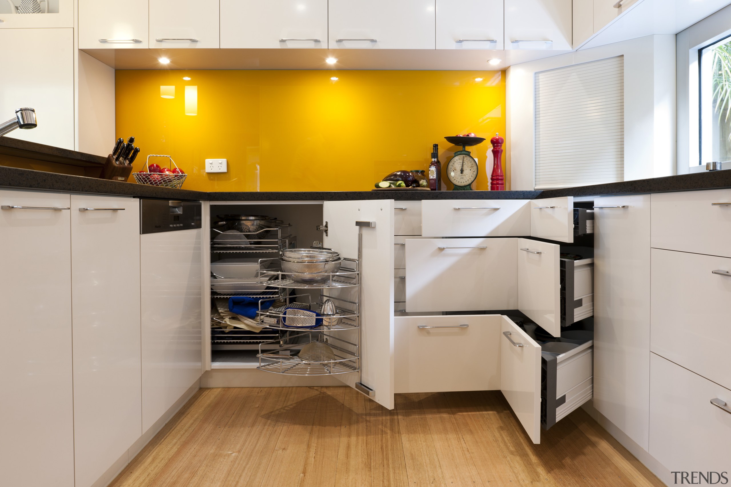 View of contemporary kitchen with yellow splashback and cabinetry, countertop, cuisine classique, floor, interior design, kitchen, room, gray